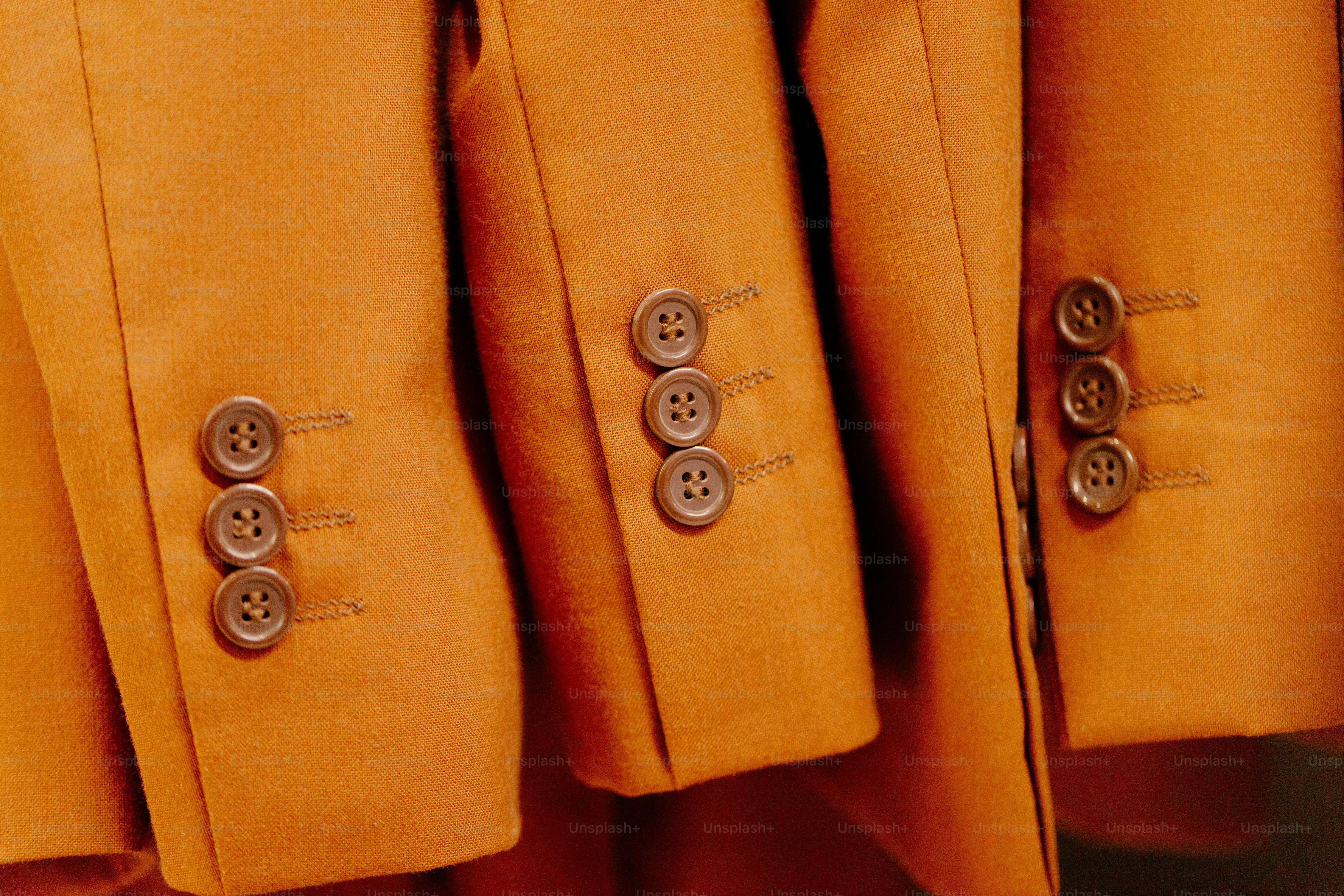 Orange blazer sleeves with brown buttons