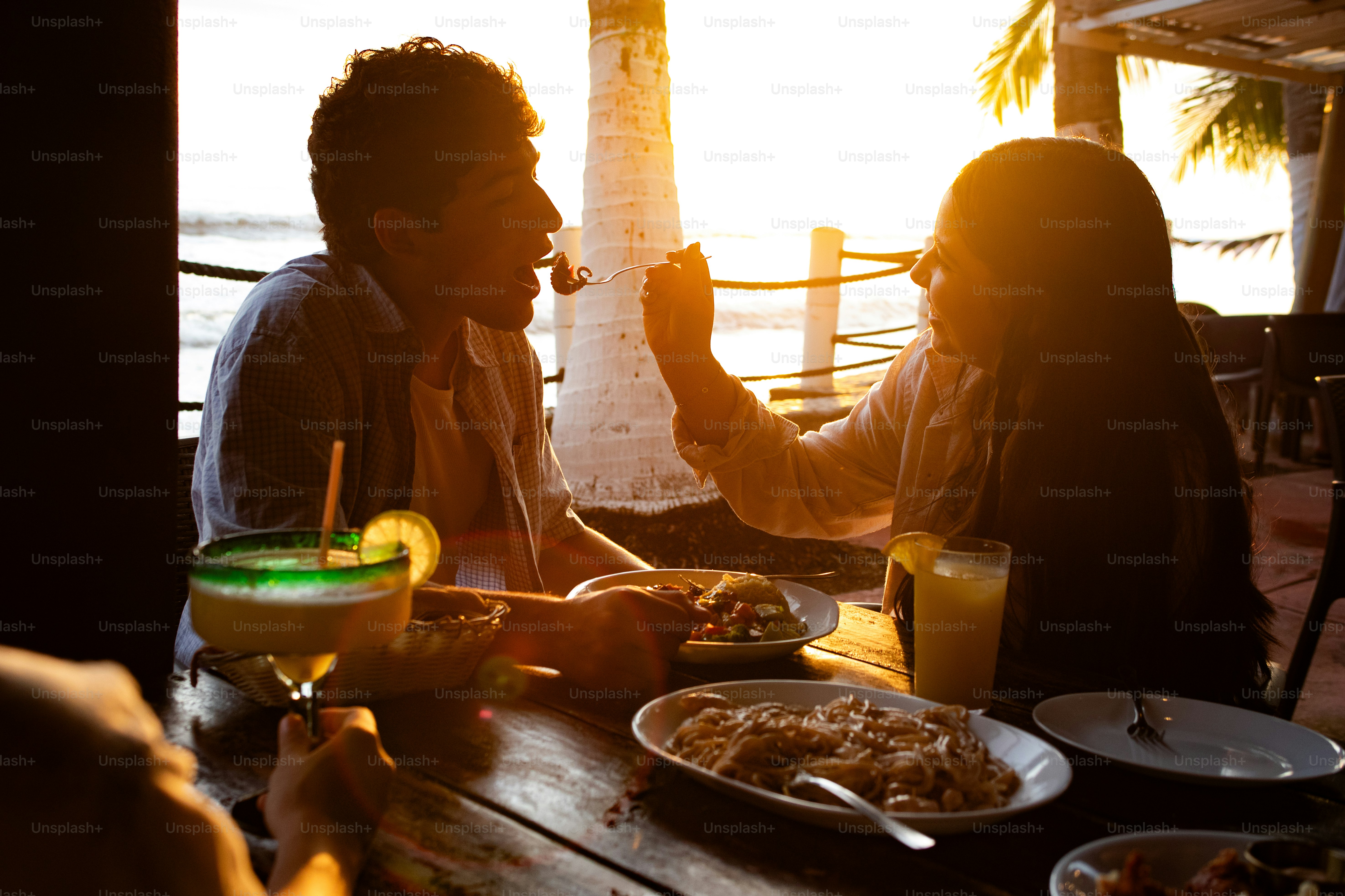 Couple sharing meal at sunset restaurant