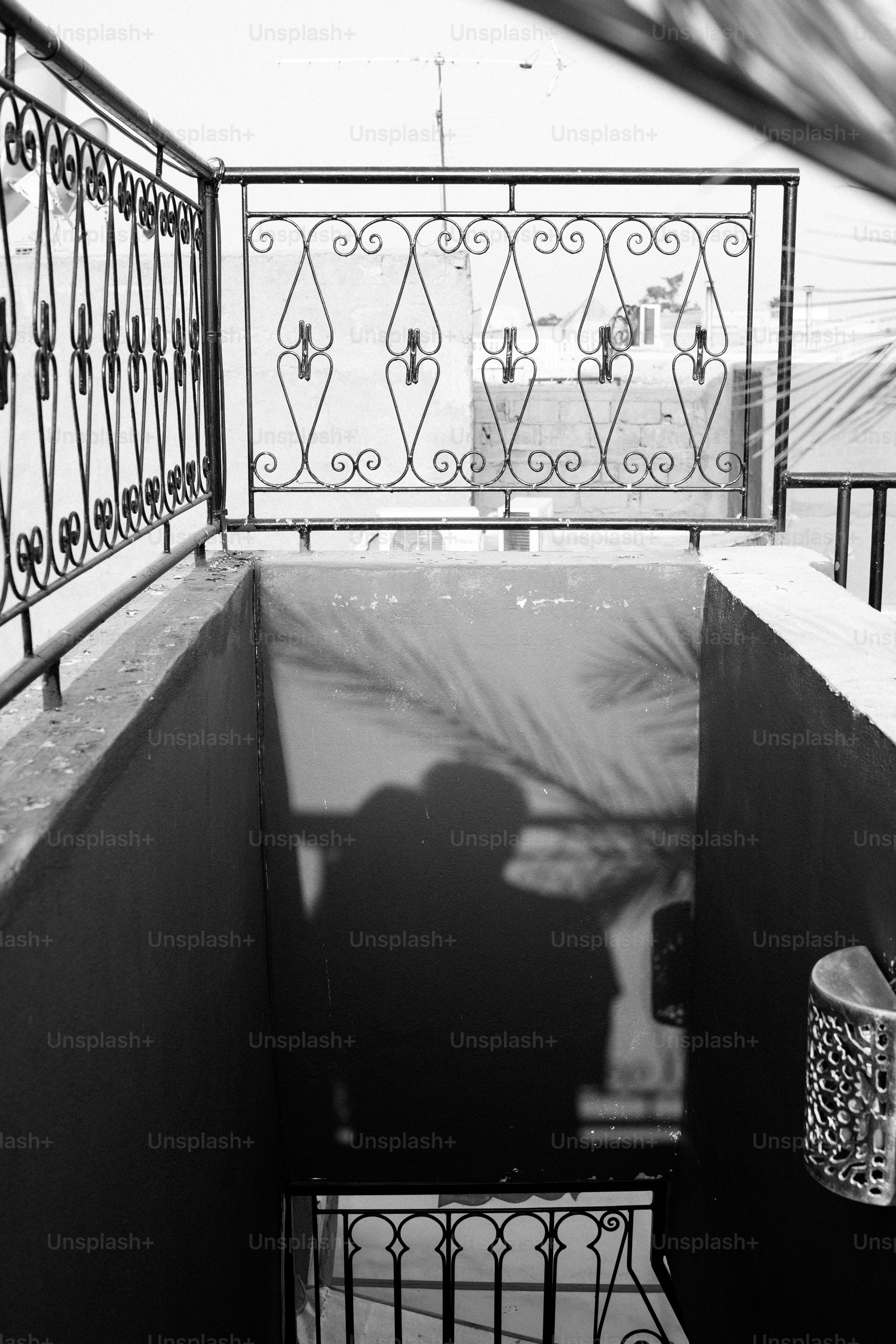 Shadows of two people on a staircase wall