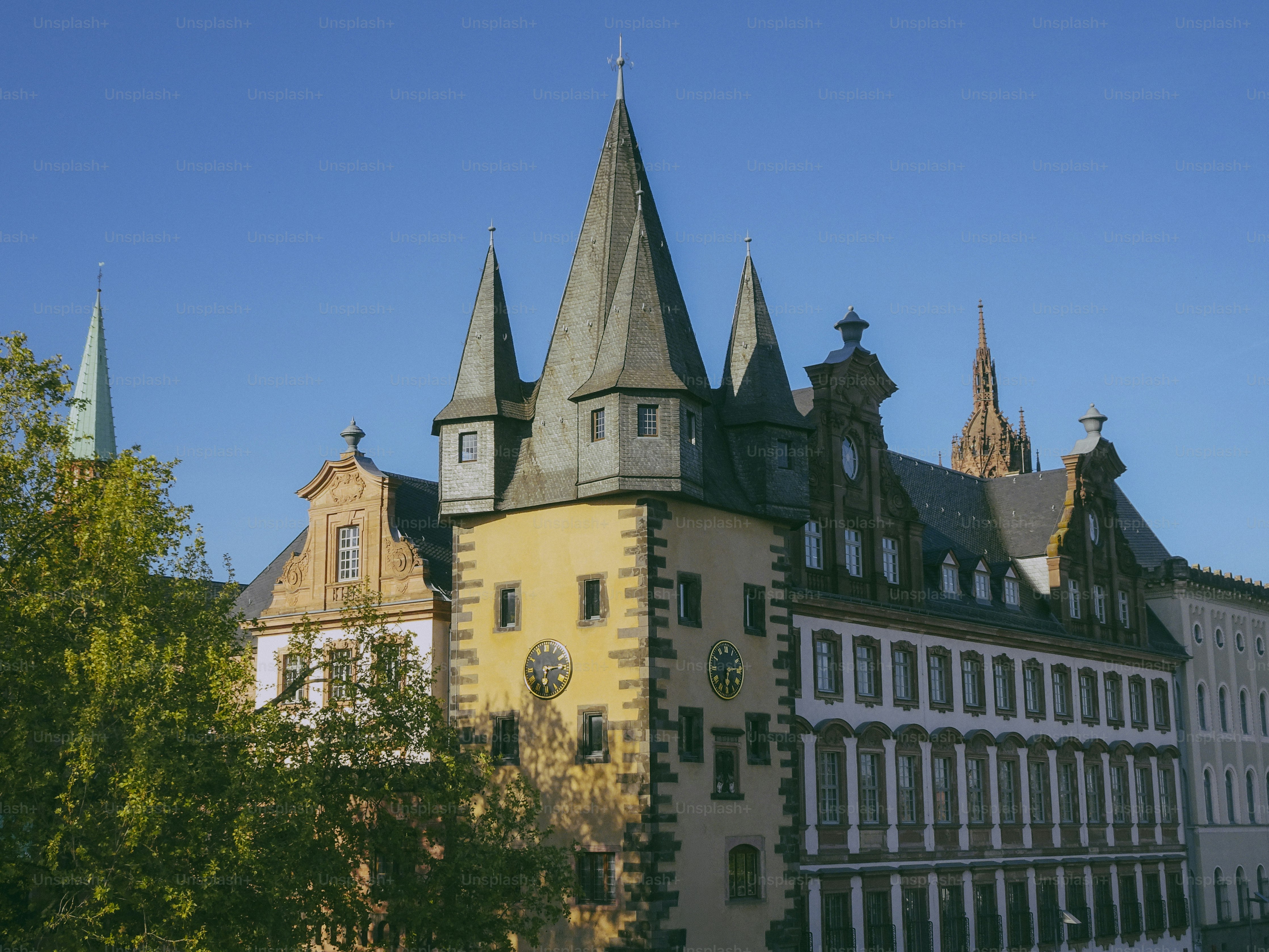 Historic building with multiple spires under blue sky