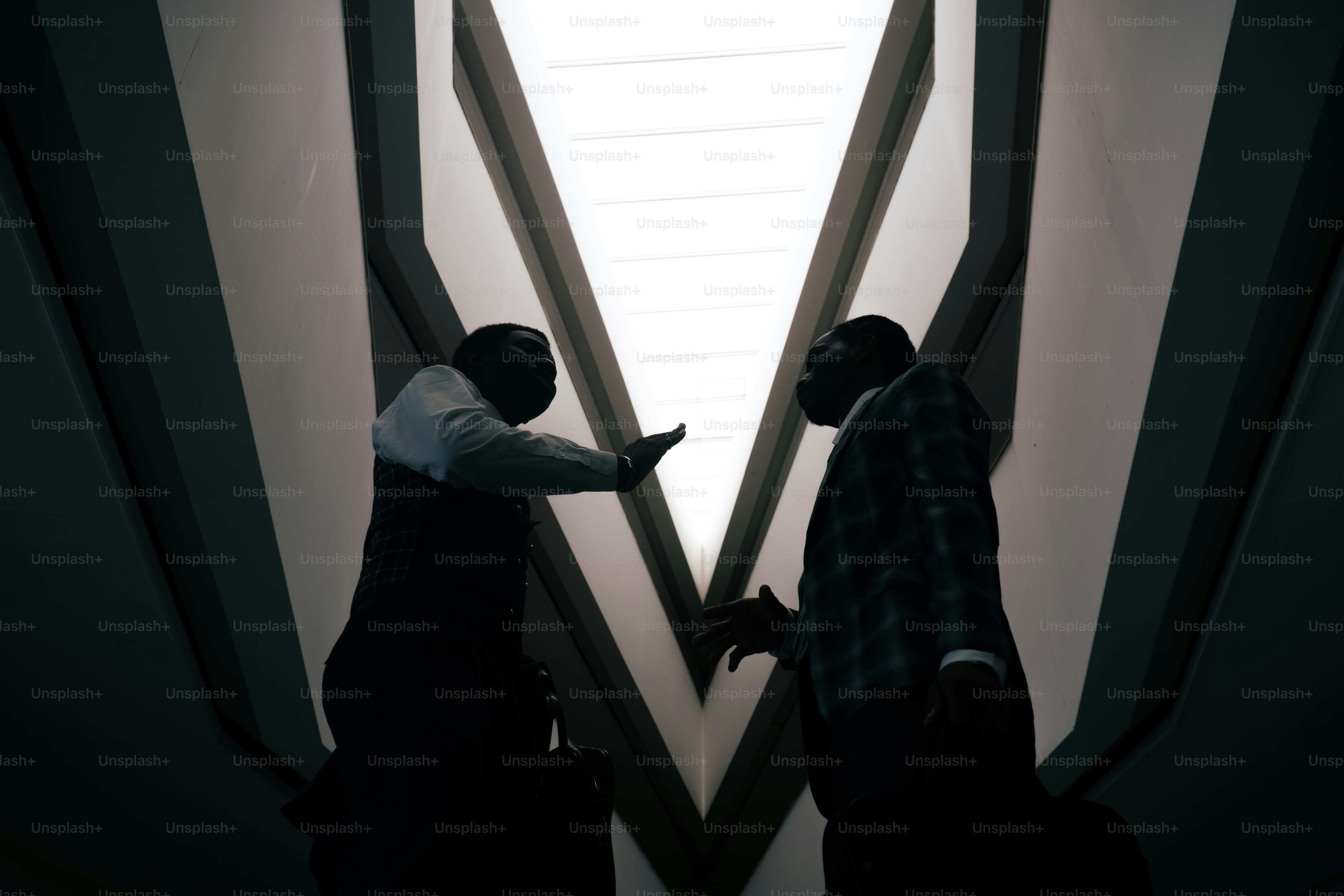 Silhouettenfiguren unter geometrischem architektonischem Licht