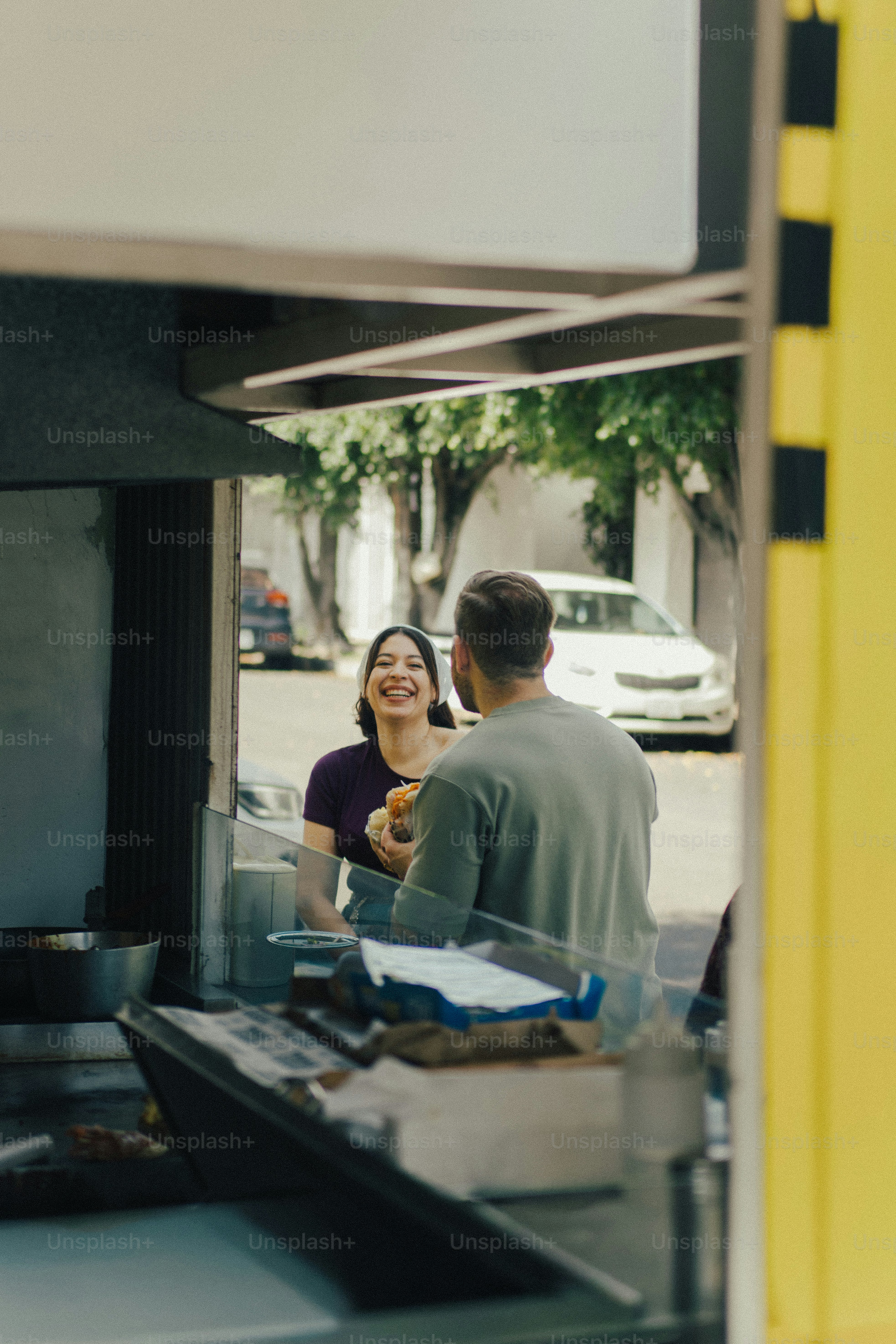 Smiling woman interacting with man at food stand