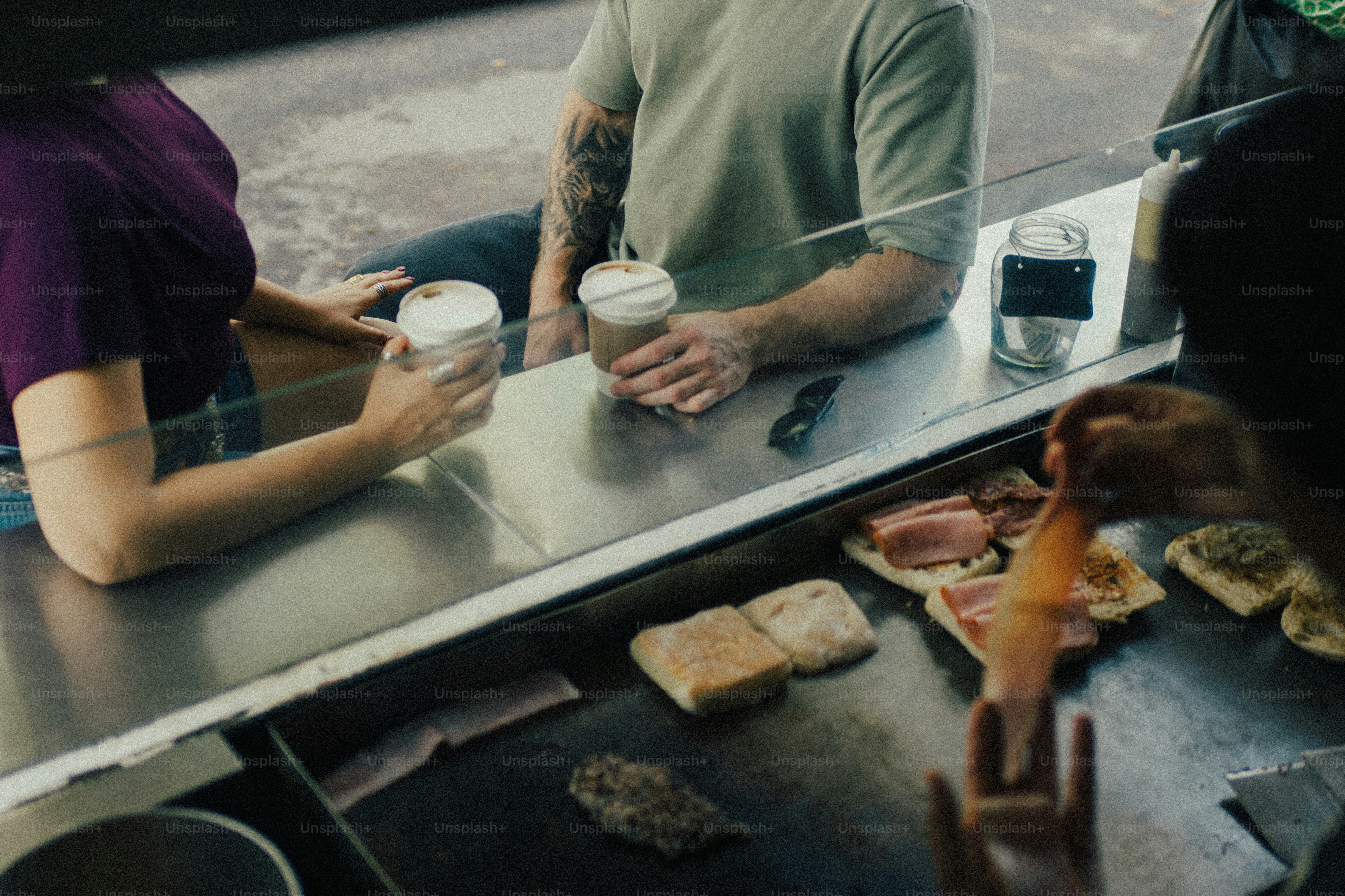 Customers receiving drinks and food at a counter