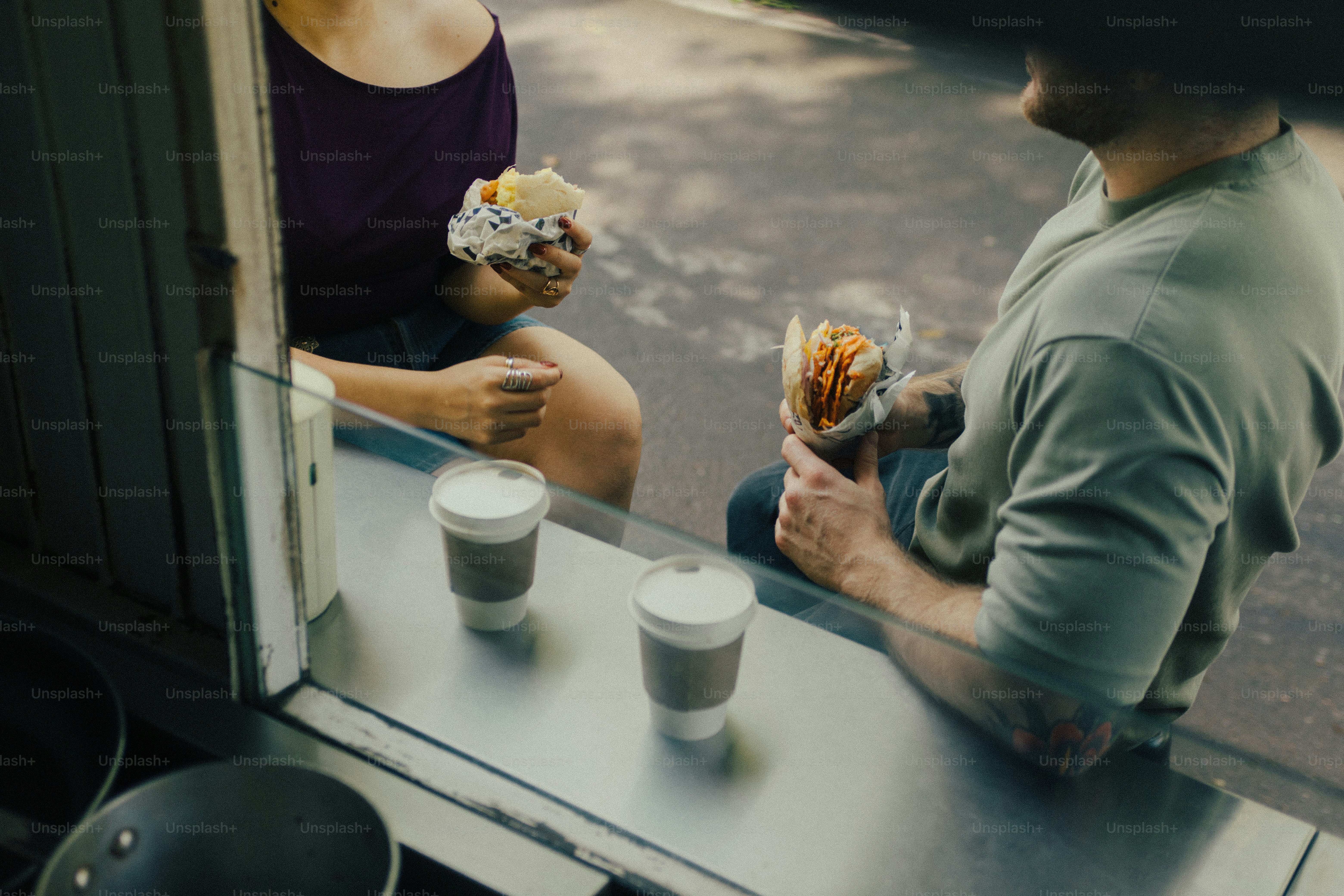 Customers enjoying food and coffee from a food truck
