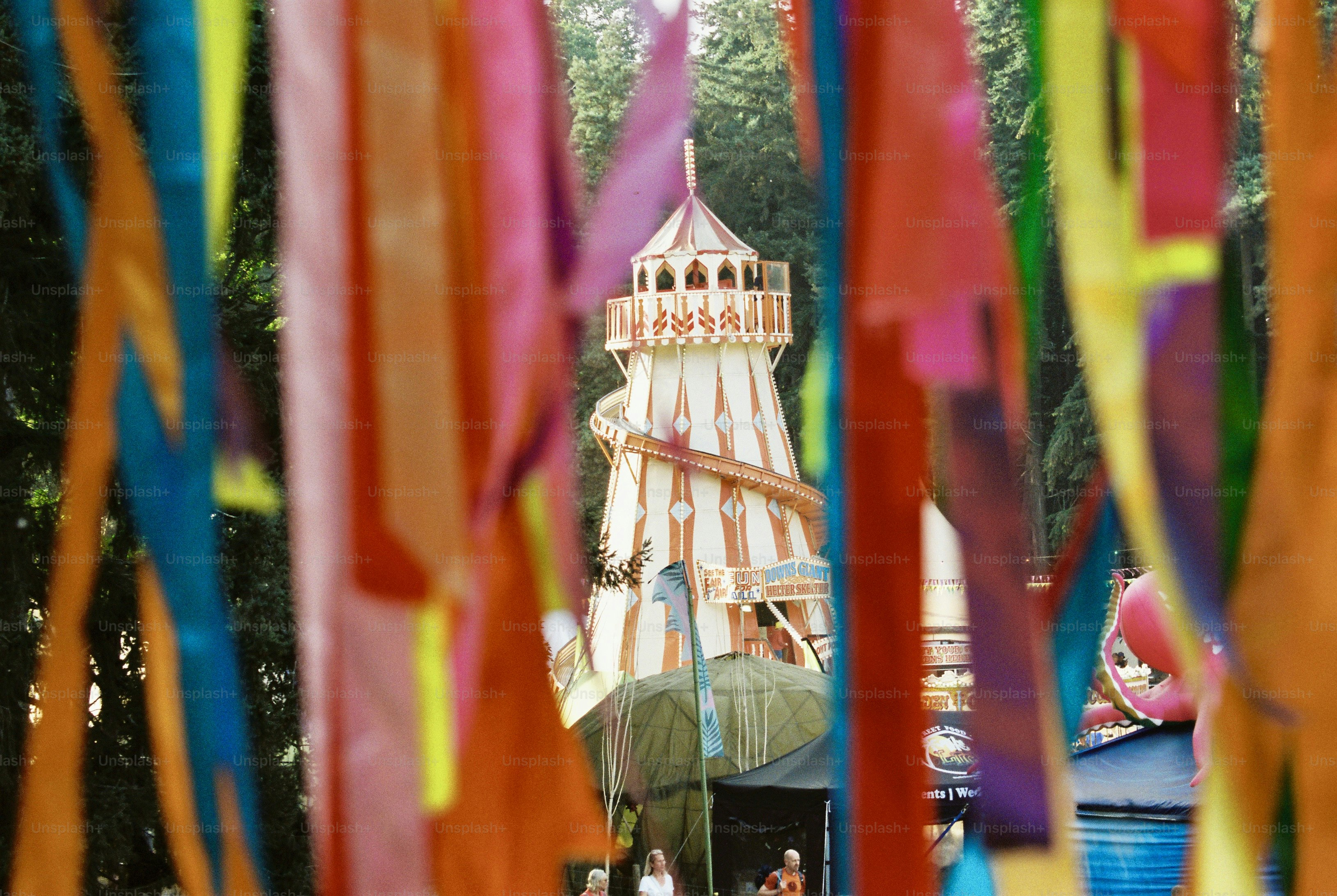 Colorful ribbons frame distant, out-of-focus helter-skelter