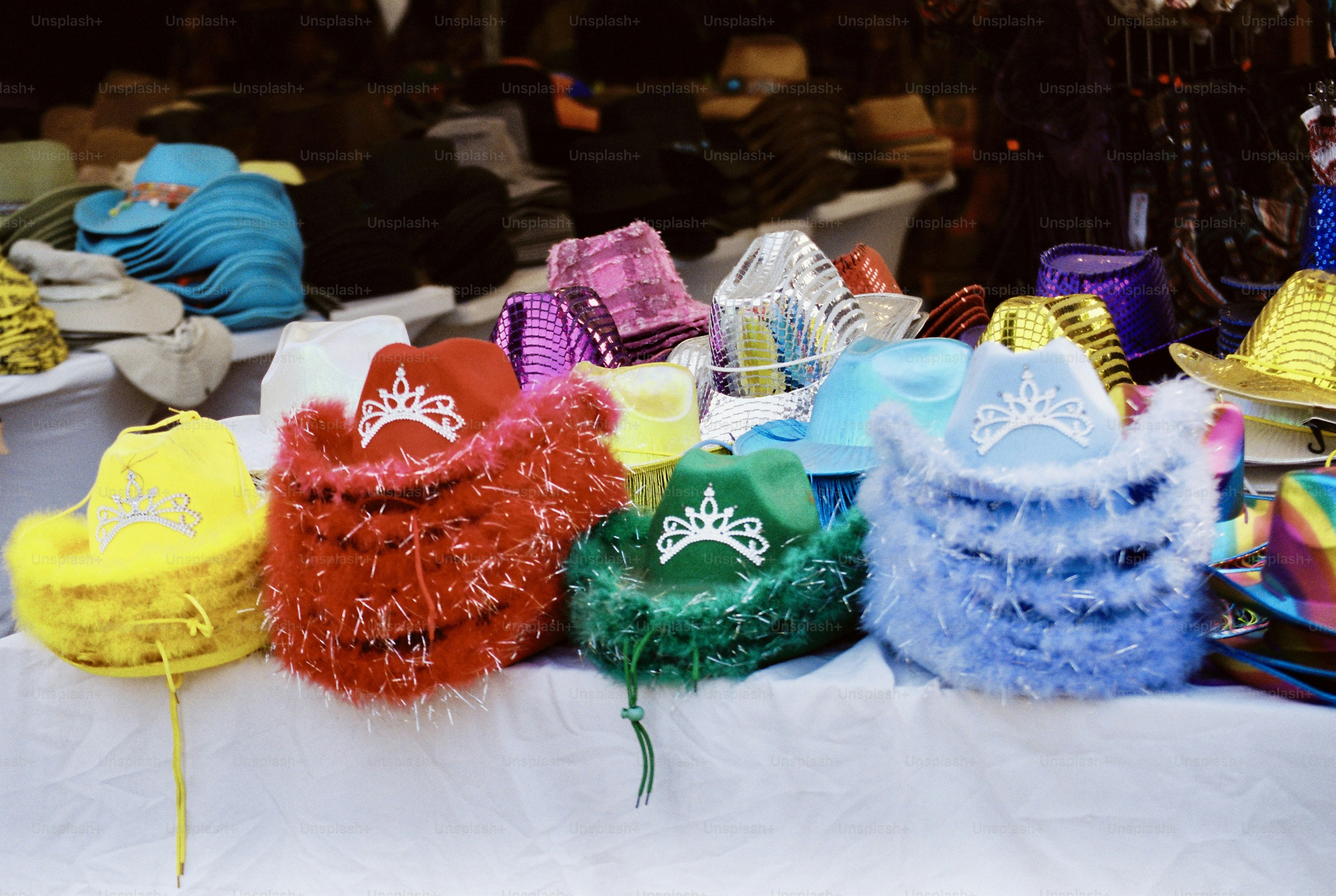 Yellow, red, green, blue tinsel cowboy hats with tiaras