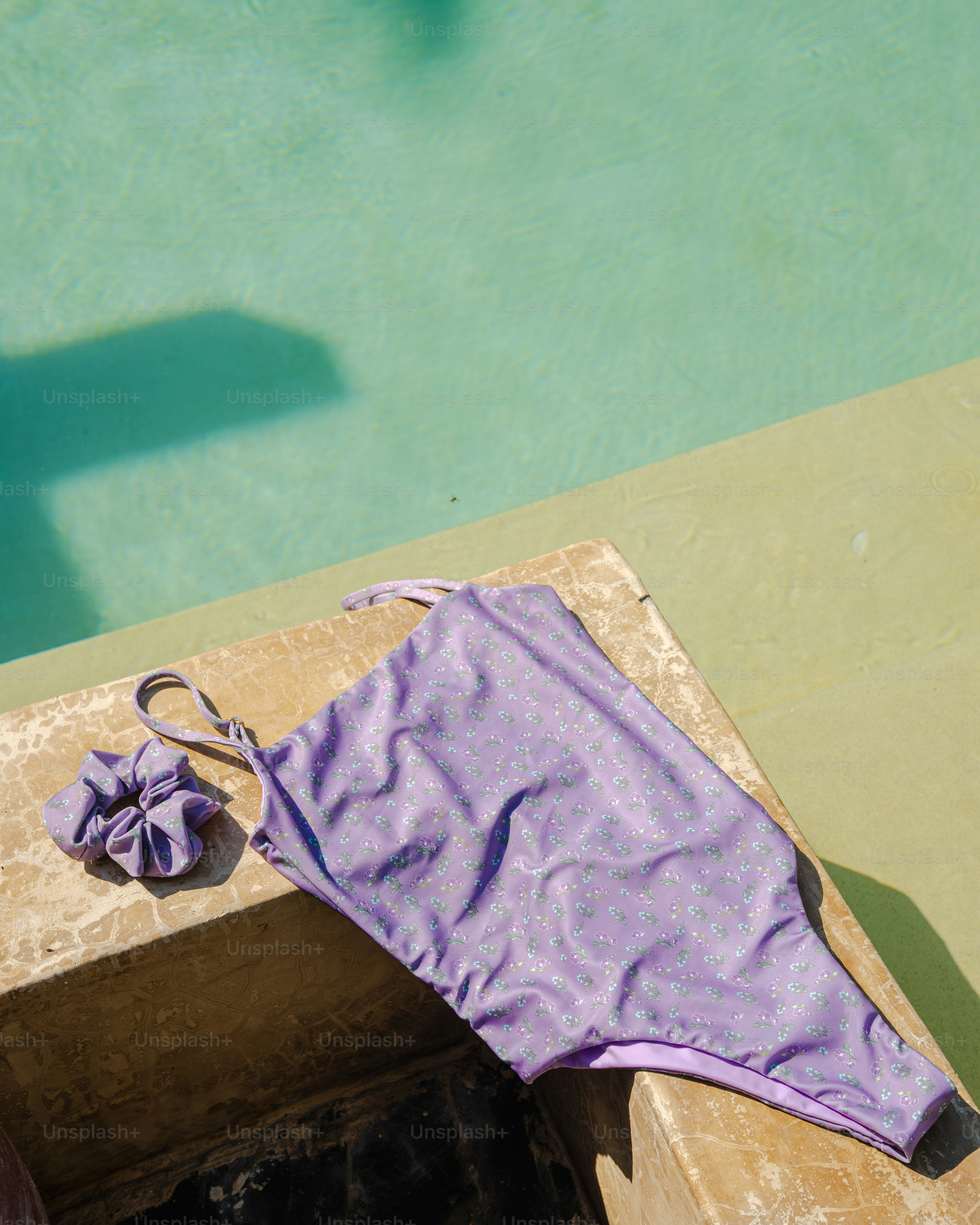 Shimmering purple swimsuit and scrunchie by pool