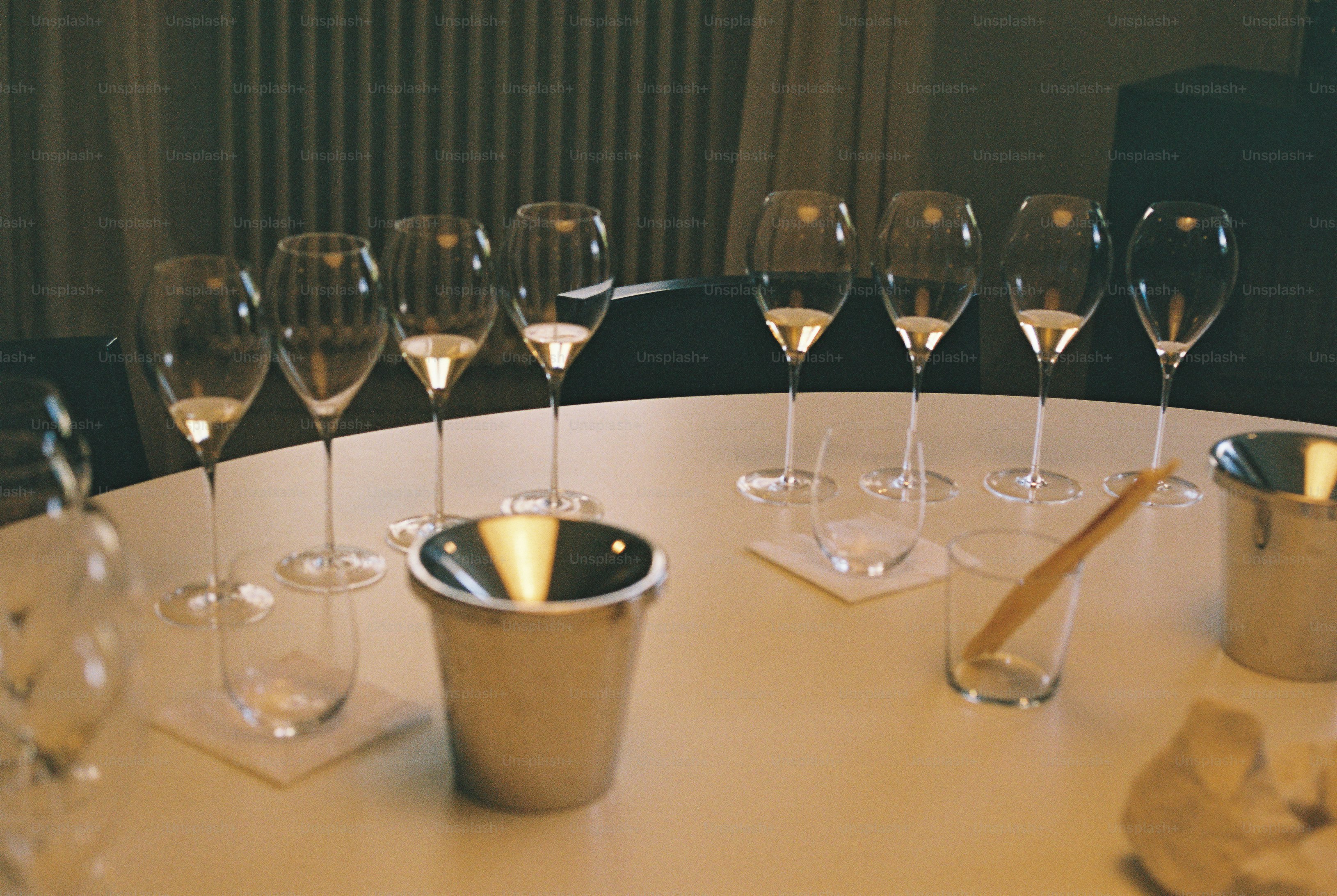 Empty champagne flutes and ice buckets on a table