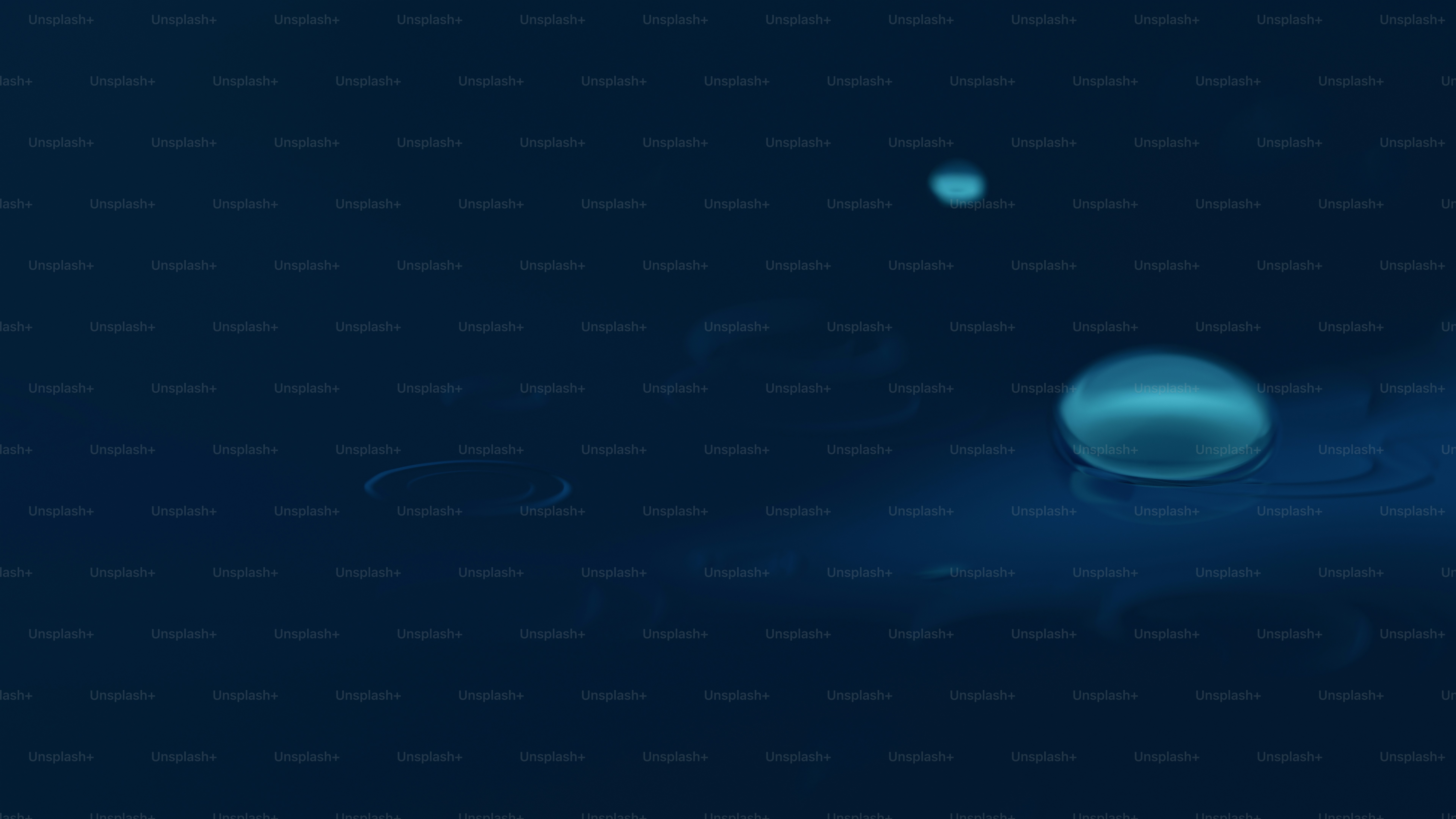 Glowing water droplet splashing on dark blue surface