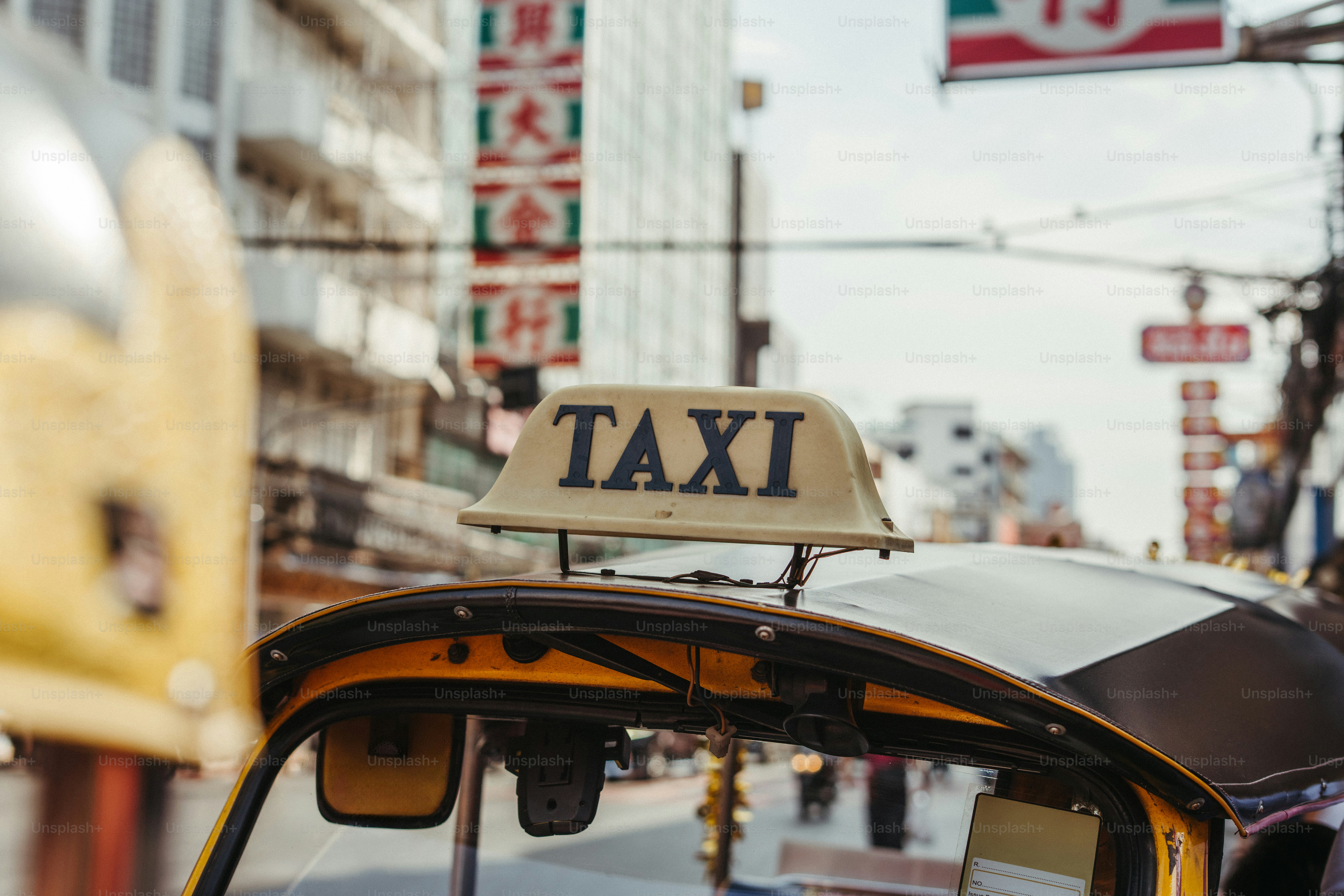 Yellow tuk-tuk taxi sign in bangkok chinatown
