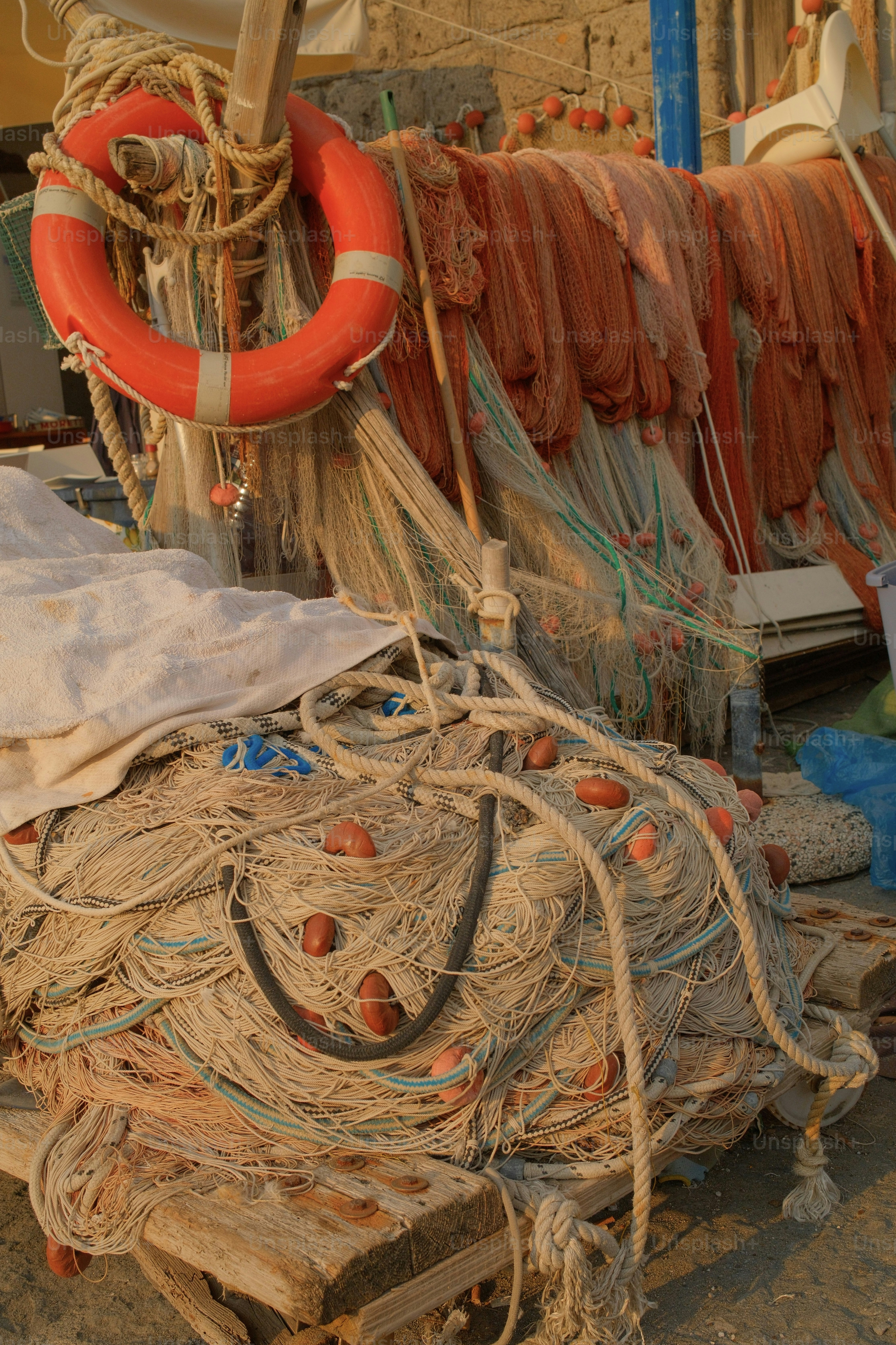 A bright orange life preserver and tangled fishing nets in Sorrento, Italy.