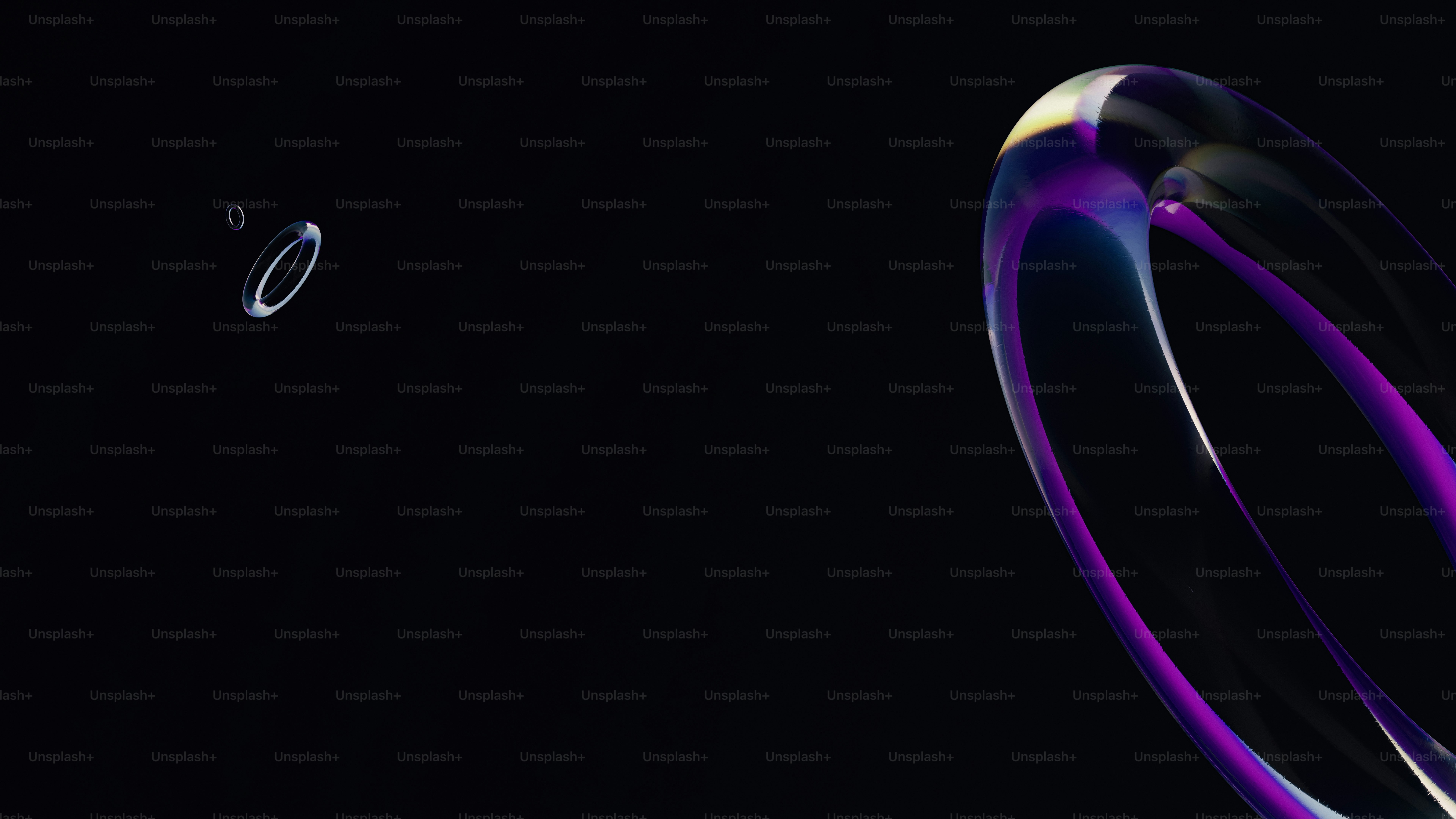Glowing purple and blue abstract rings on black.