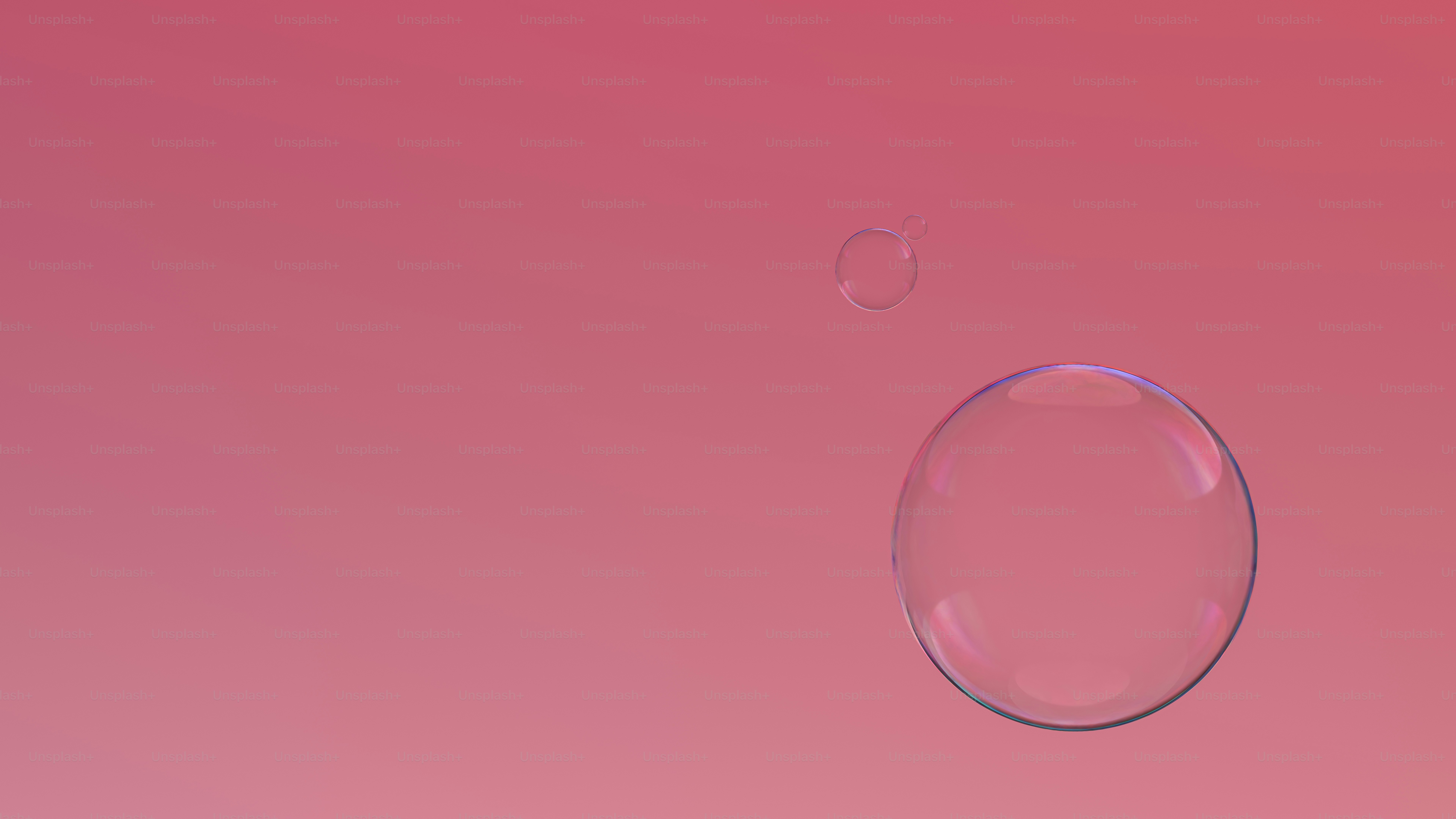 Two bubbles floating against a pink gradient background