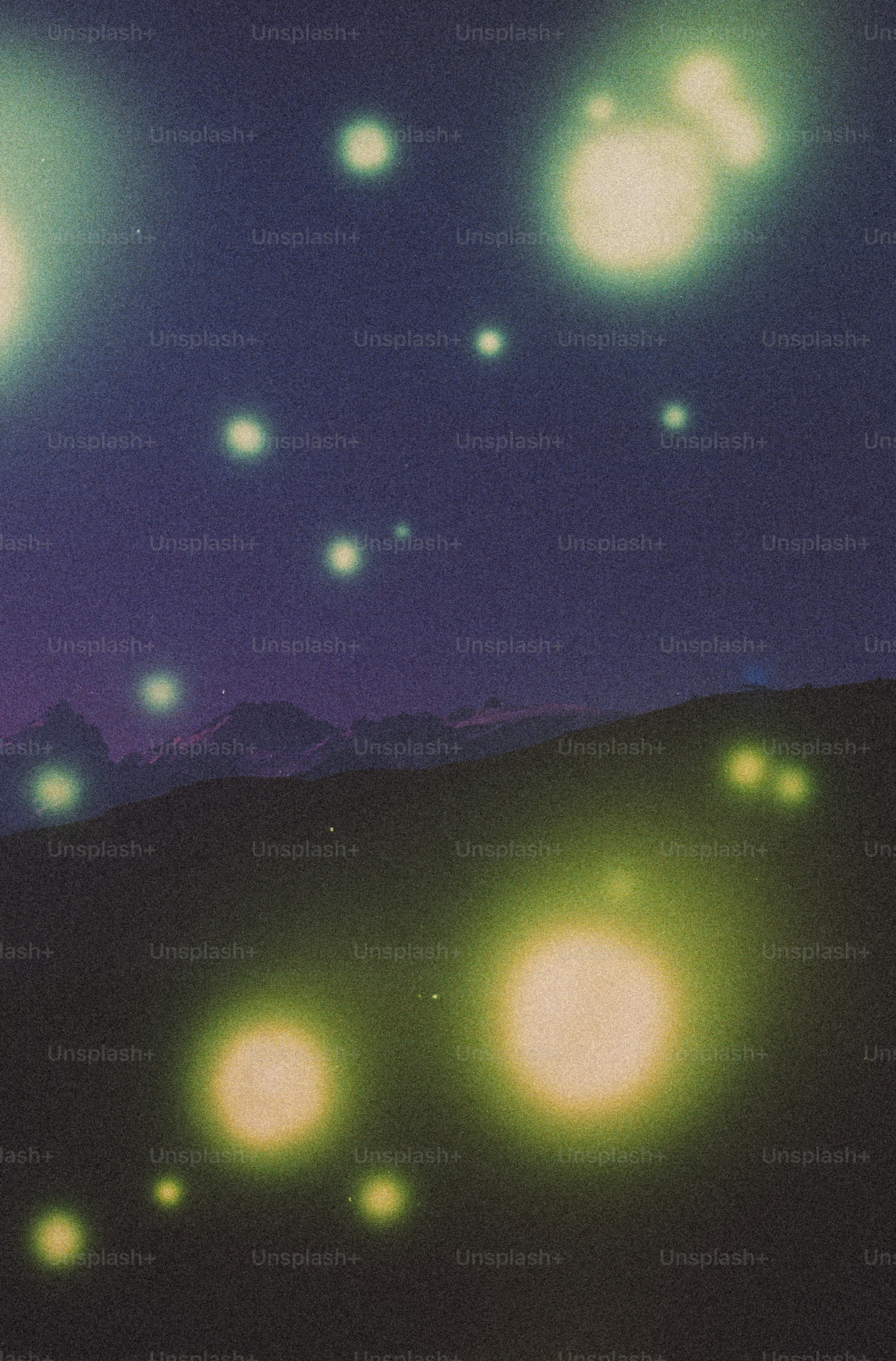 Green and yellow orbs glow over dark hills