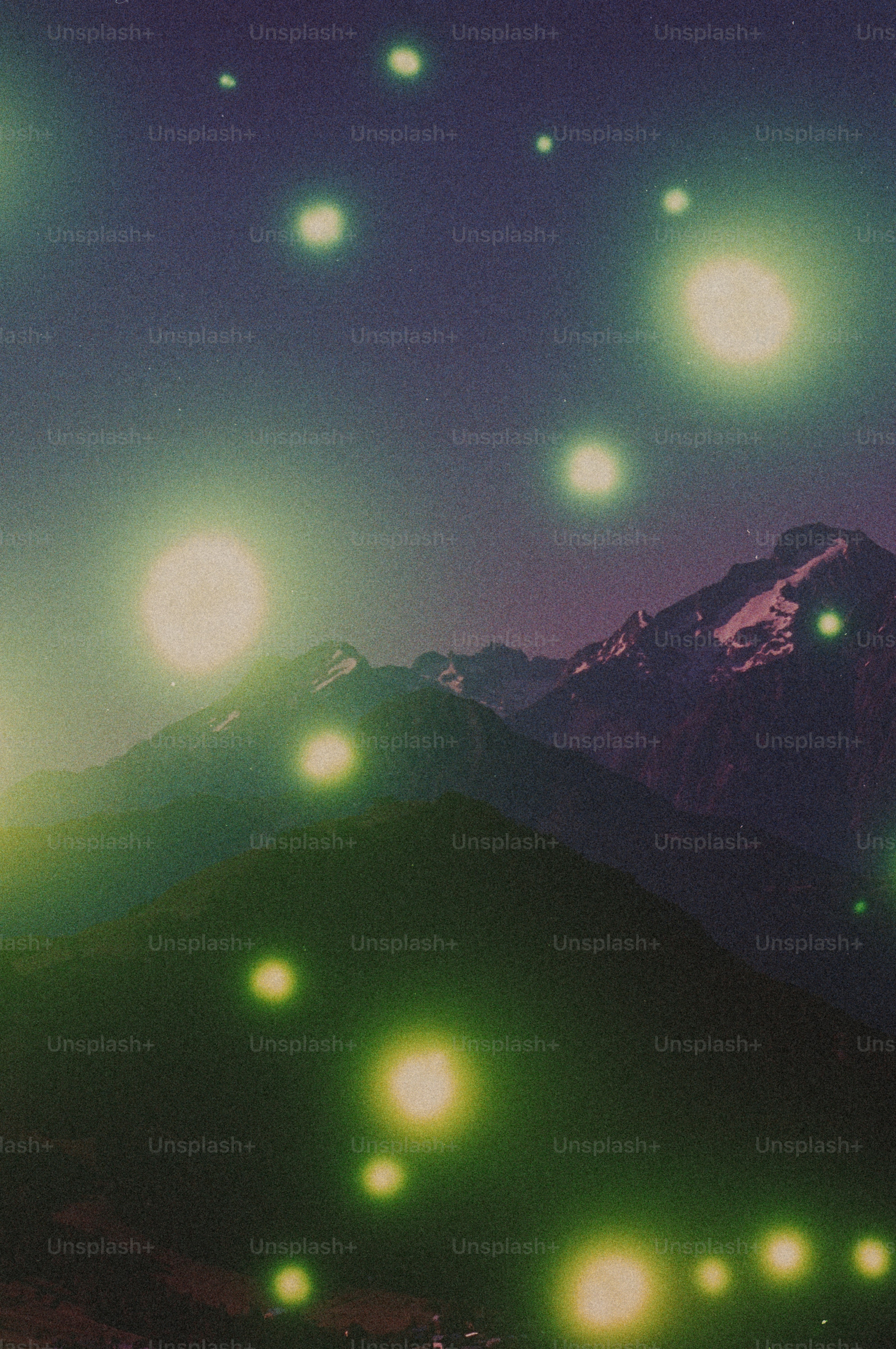 Glowing orbs over snow-capped mountains