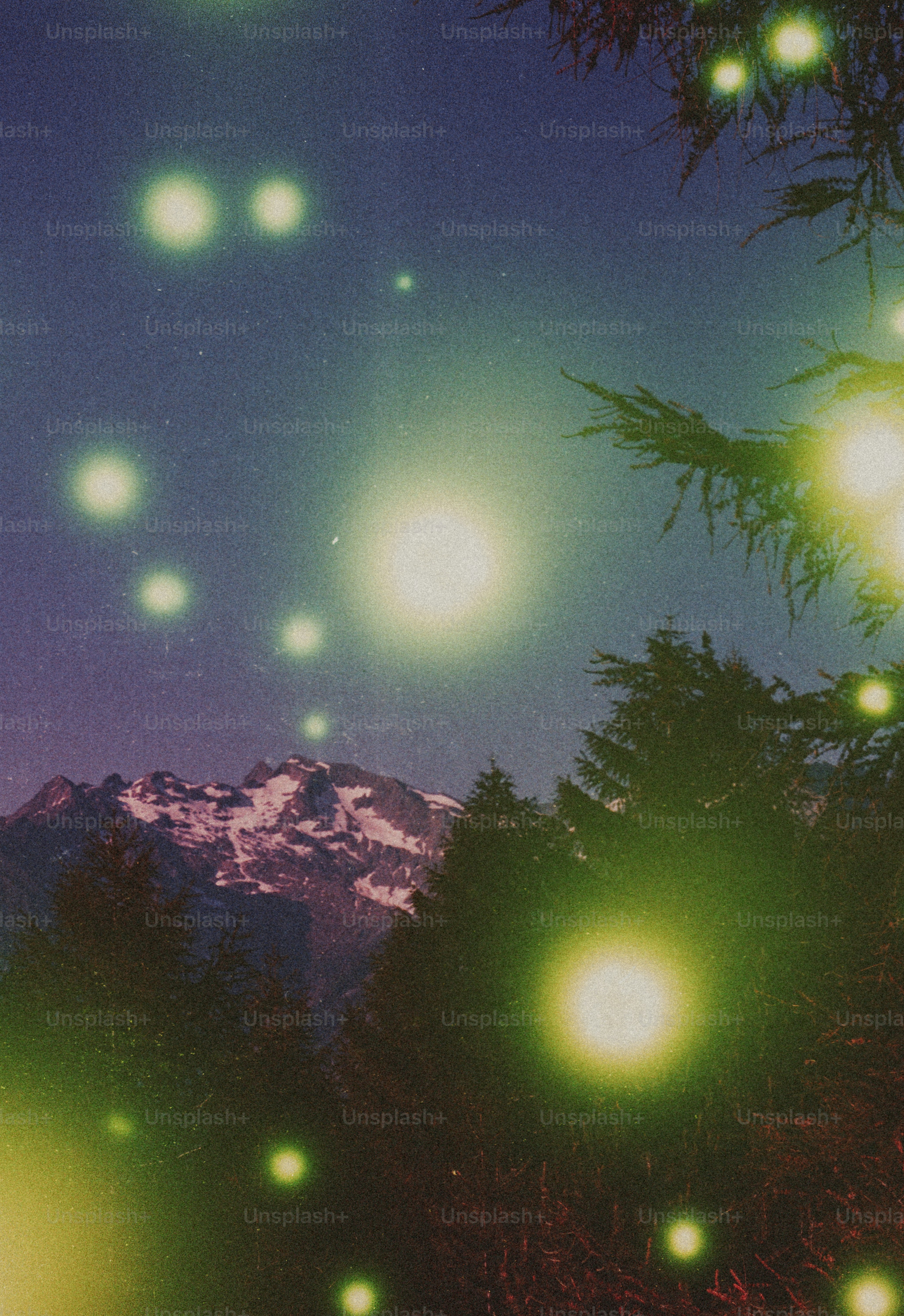 Bright glowing orbs above snowy mountain and forest