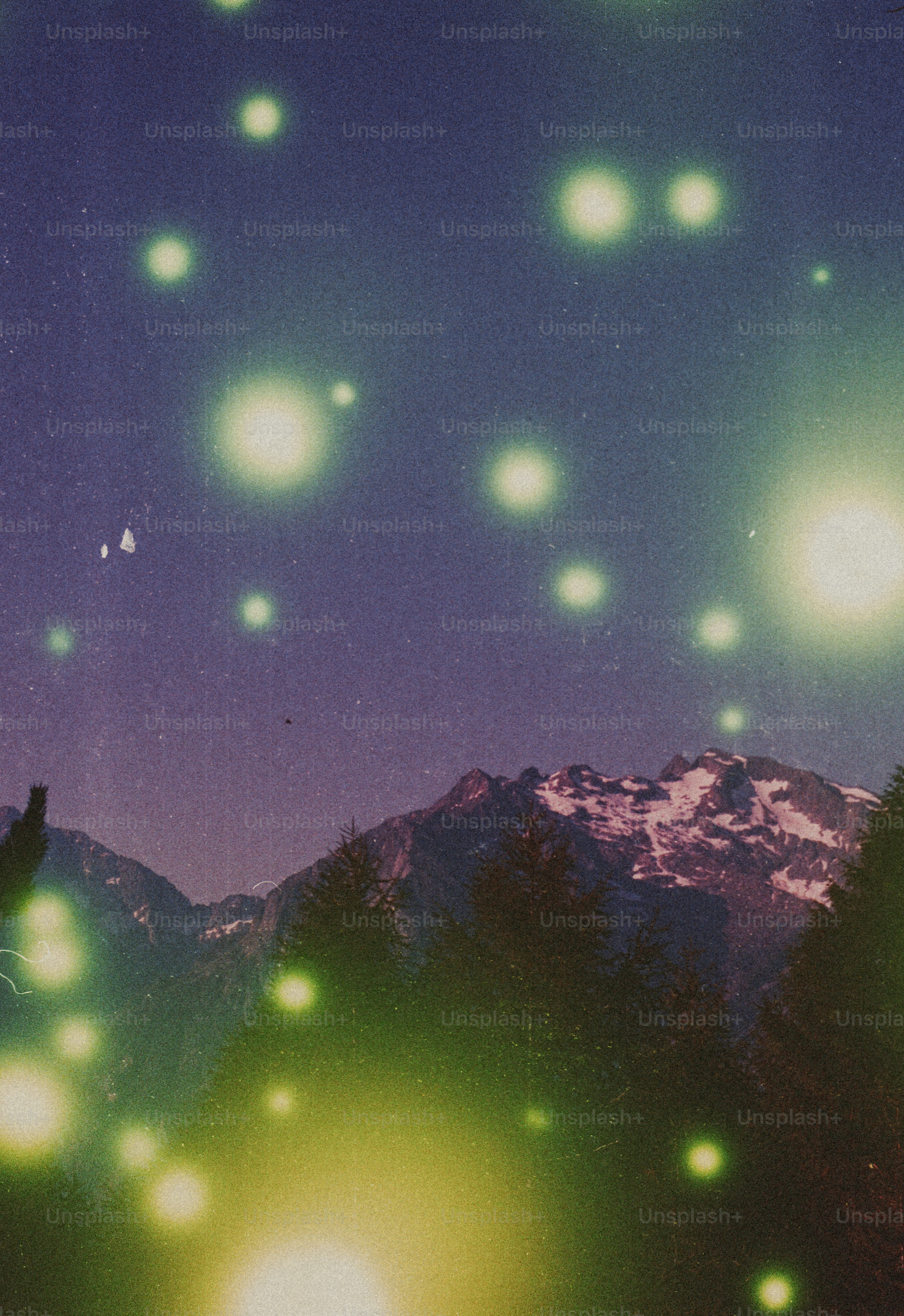 Ethereal glowing lights over snow-capped mountains