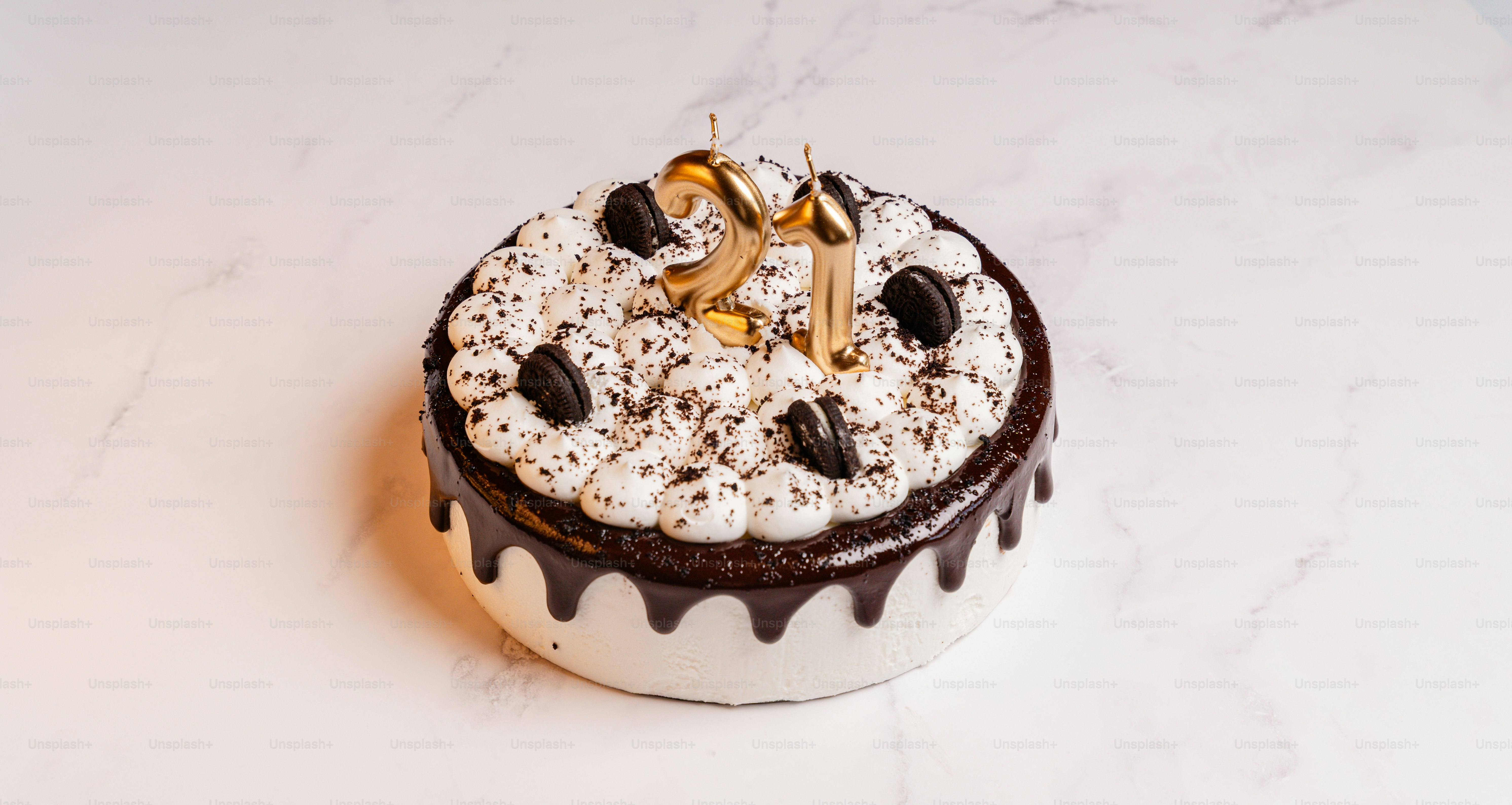 Chocolate drip cake with '21' candles and cookie pieces