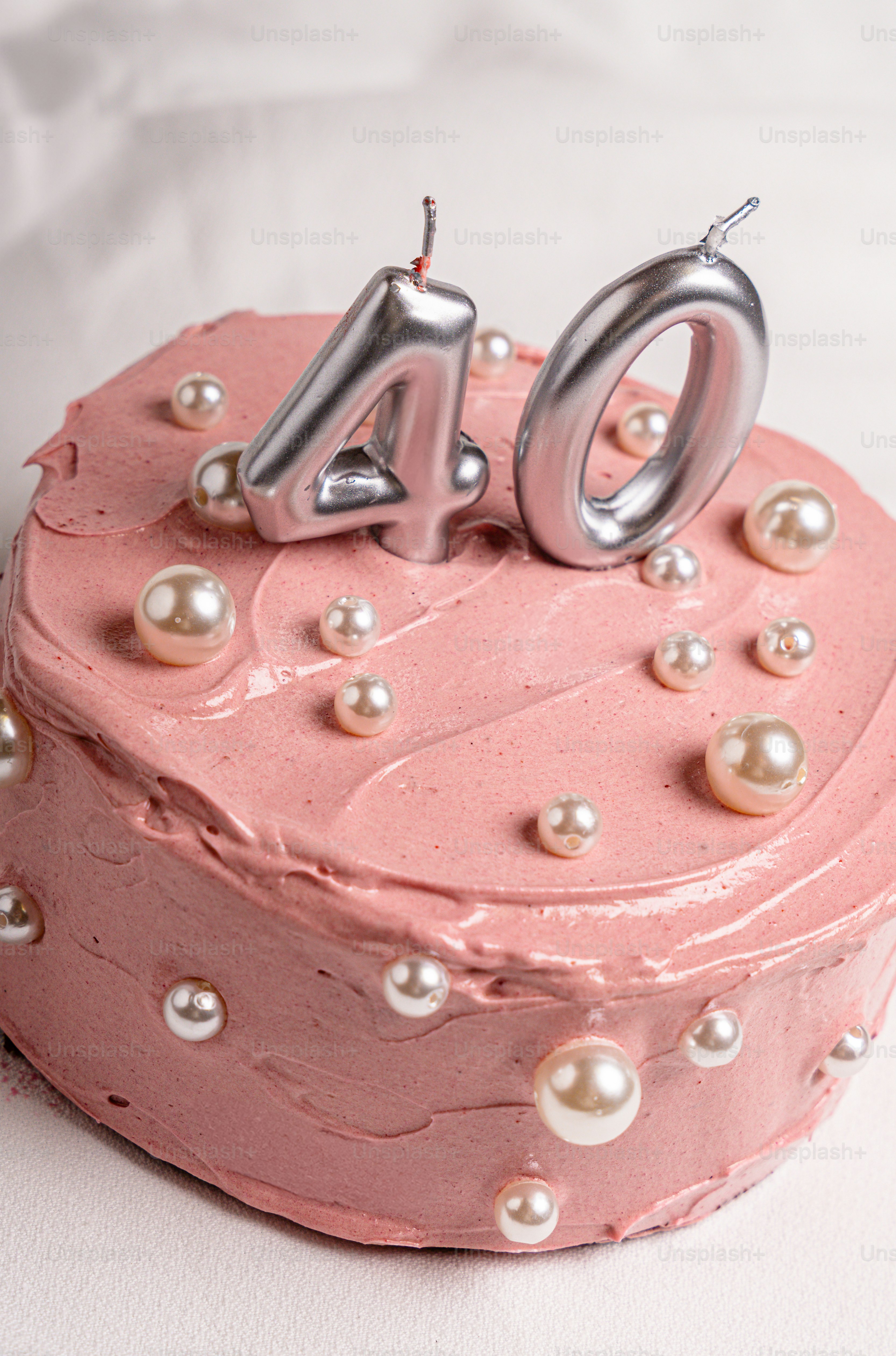 Pink cake with silver 40 candles and white pearls