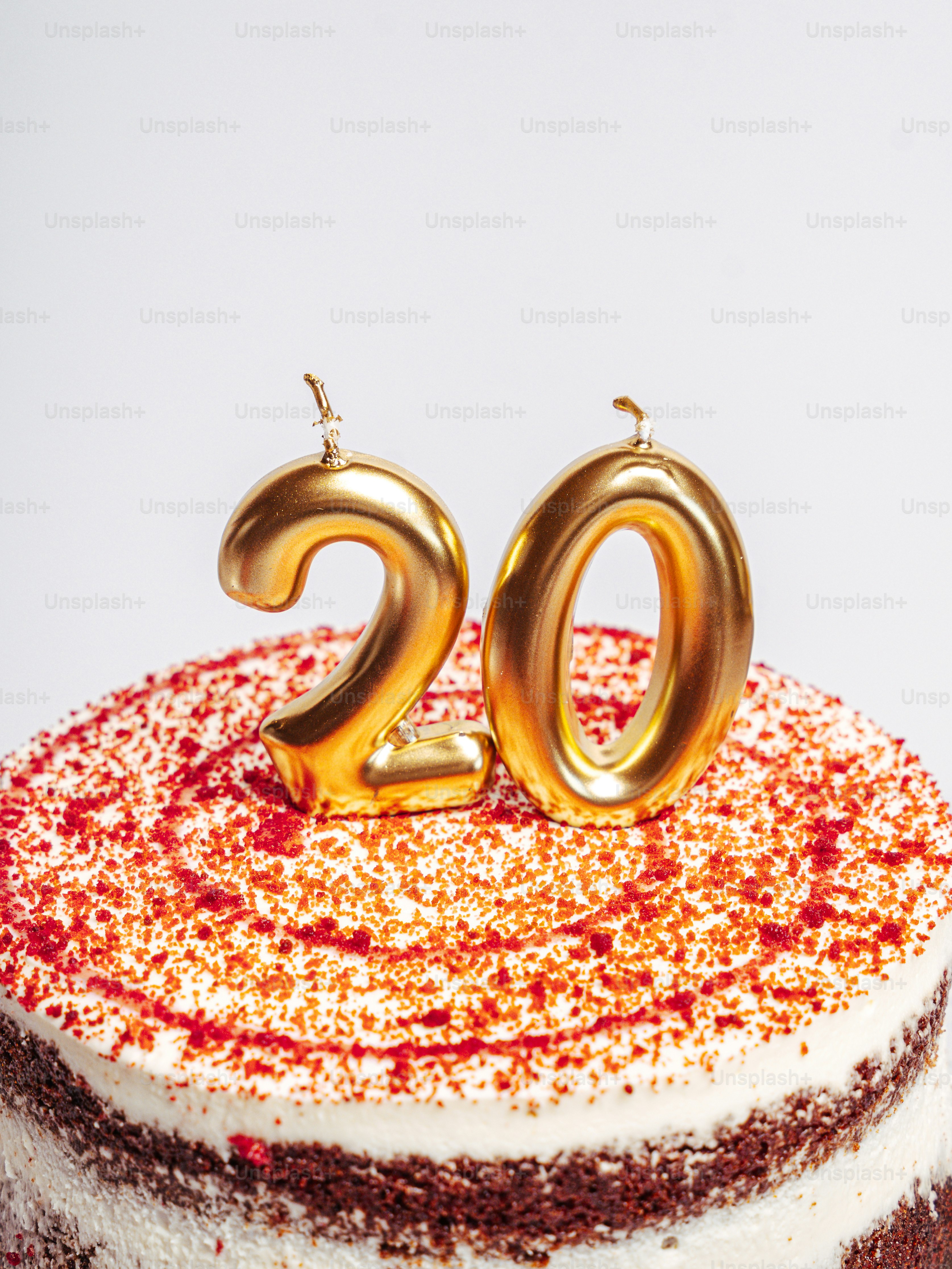 Gold 20 candles on red velvet cake