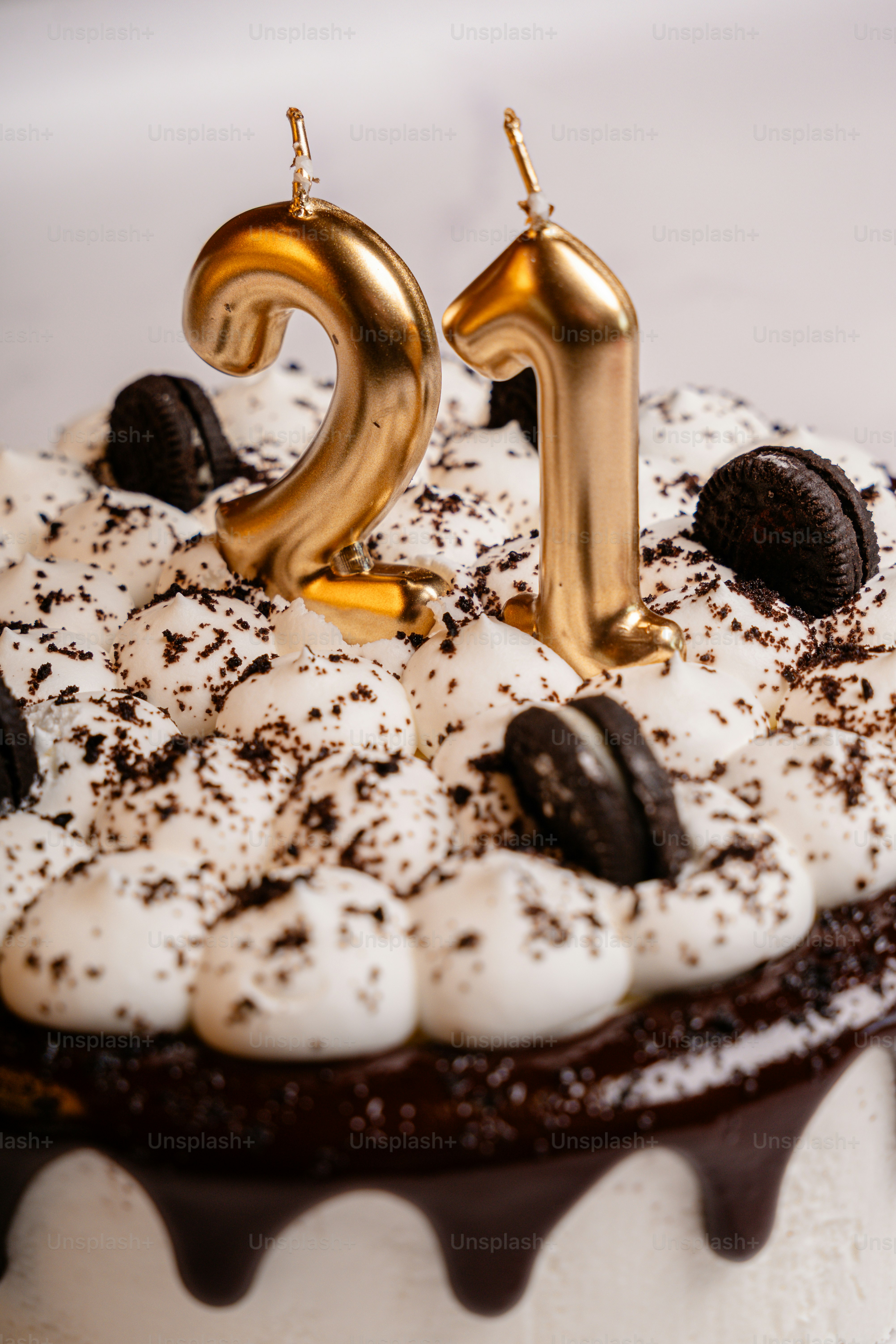 Birthday cake with golden 21 candles and cookies