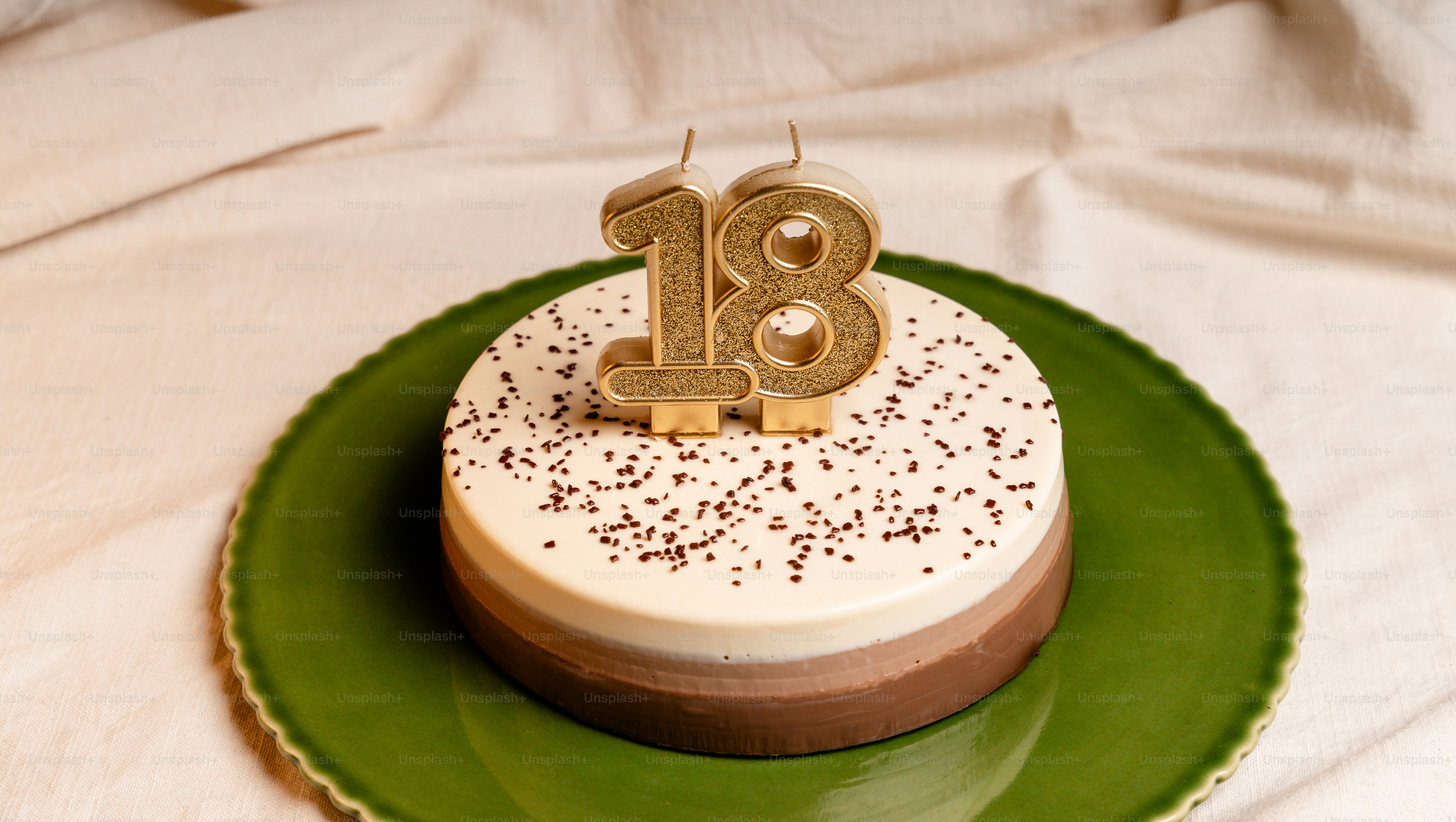 Three-layered cake with gold 18 candles