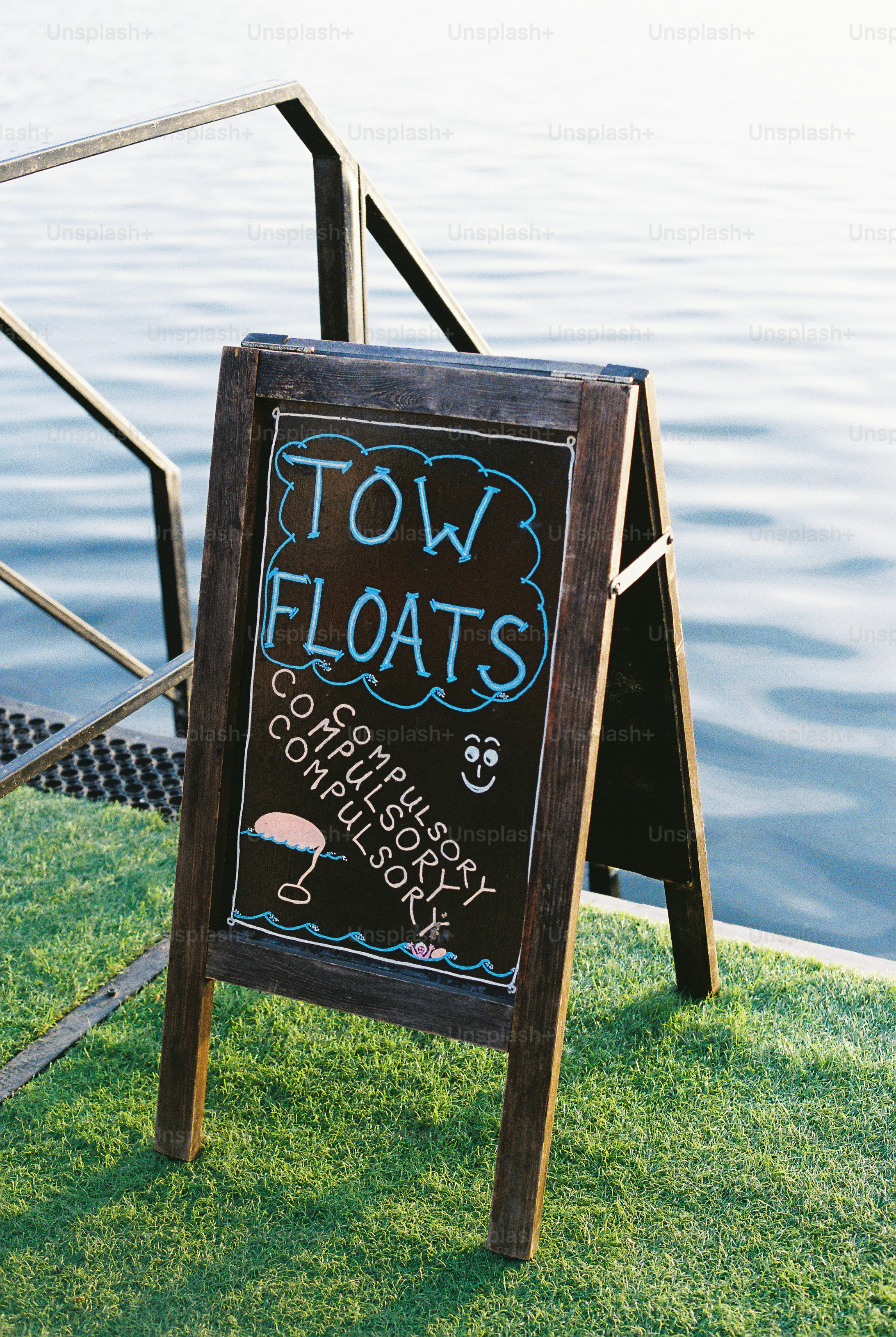 Tow floats compulsory sign by the water