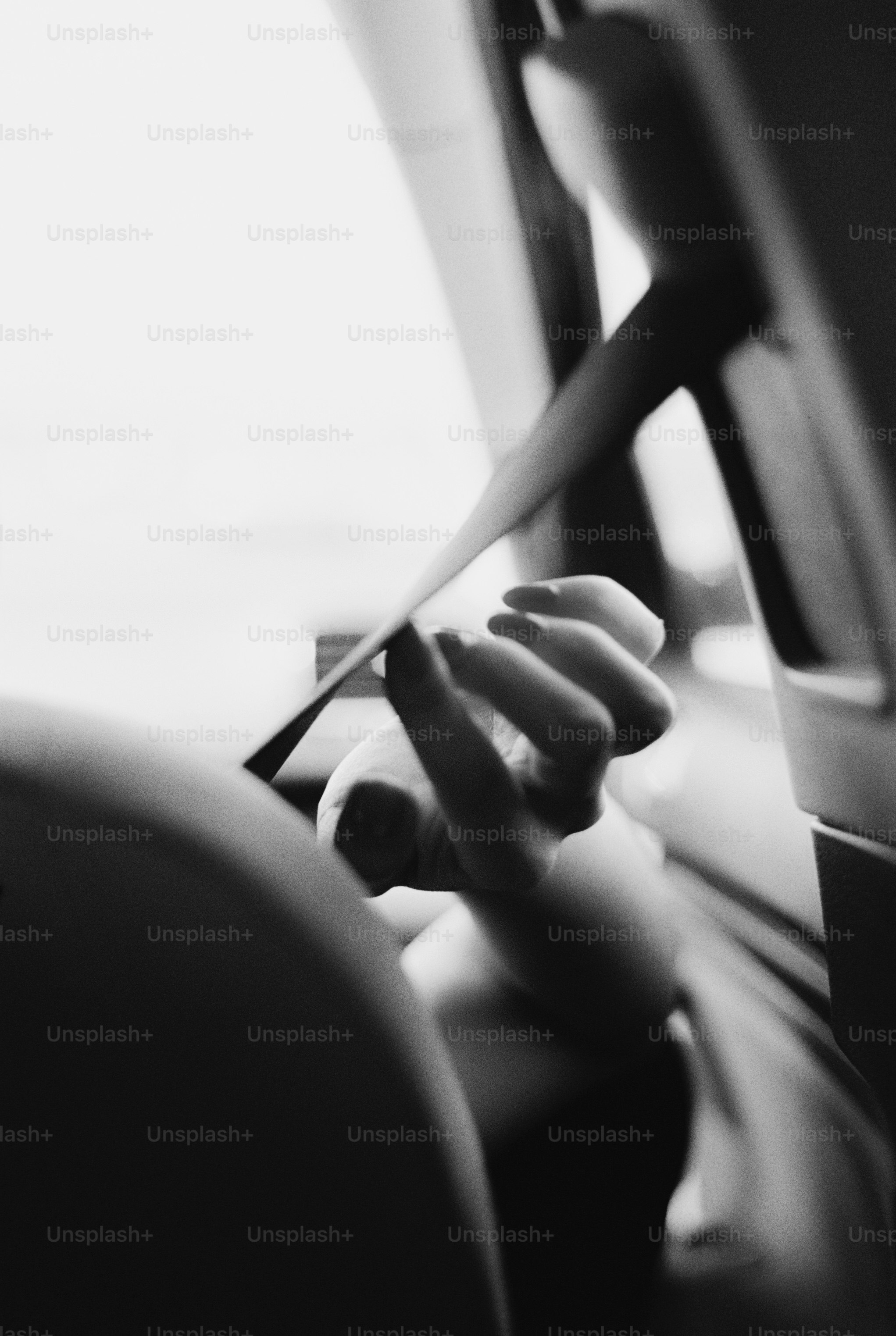 Hand securing car seatbelt in black and white