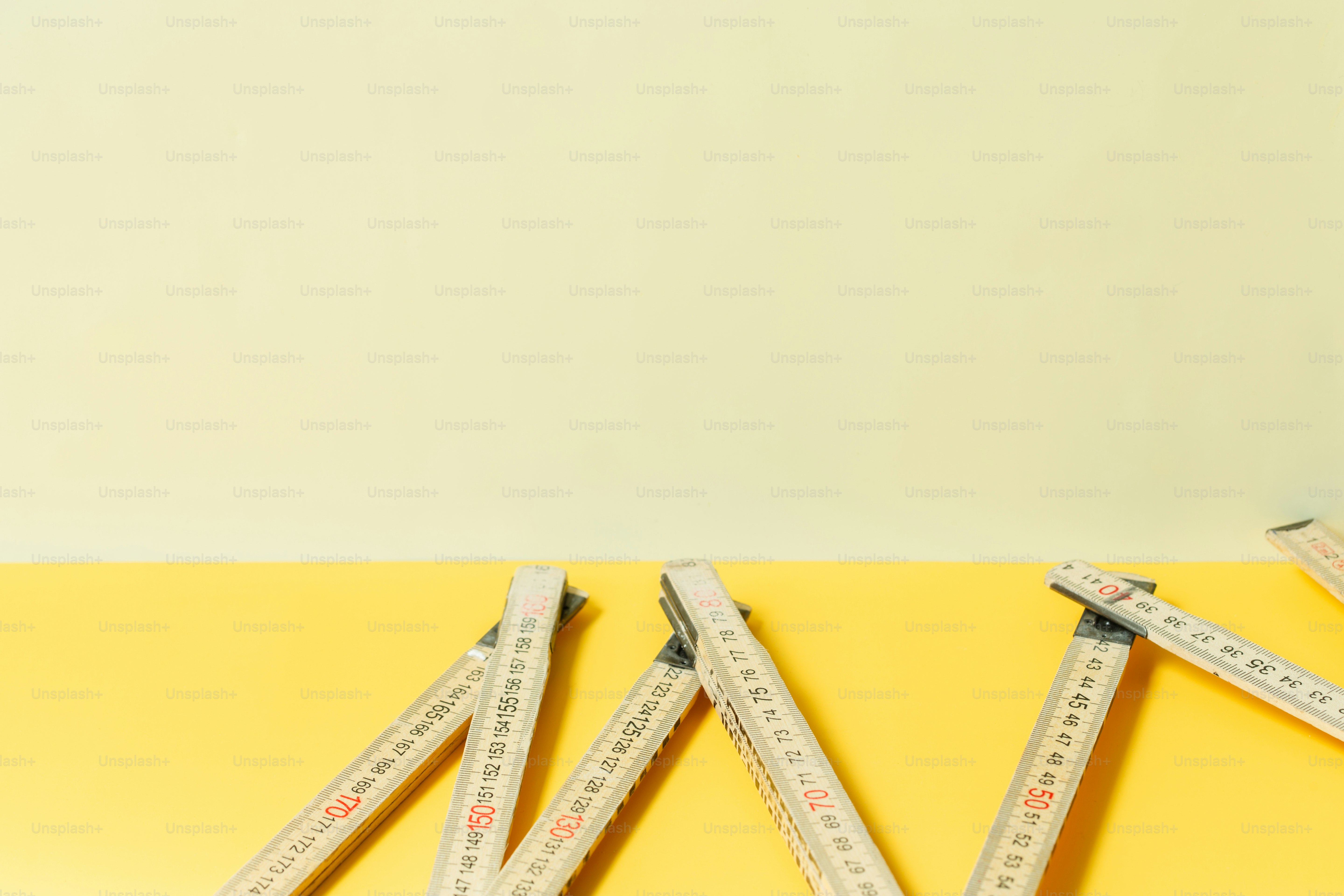Folding ruler on a two-tone yellow background