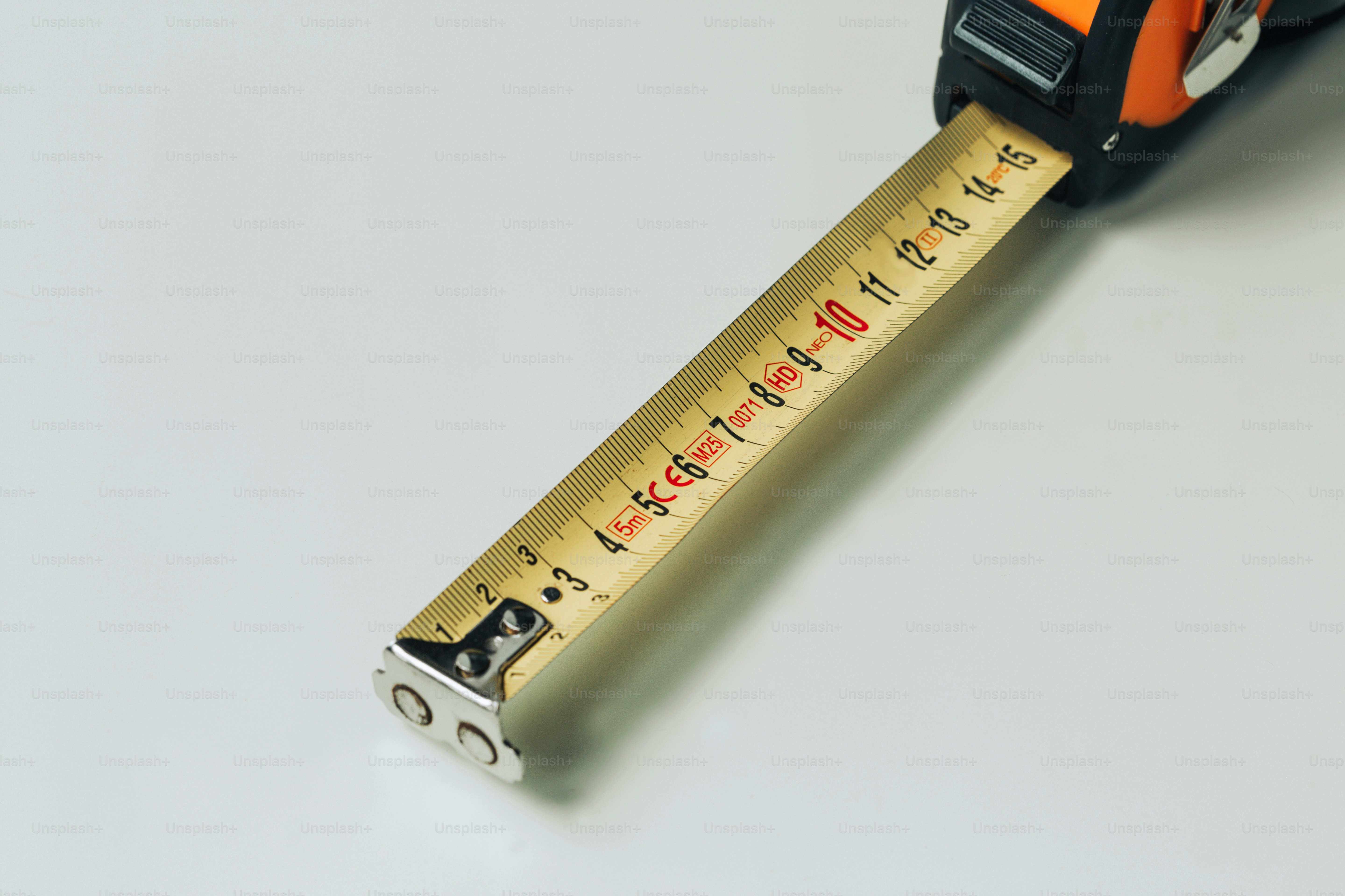 Measuring tape extended on a white surface