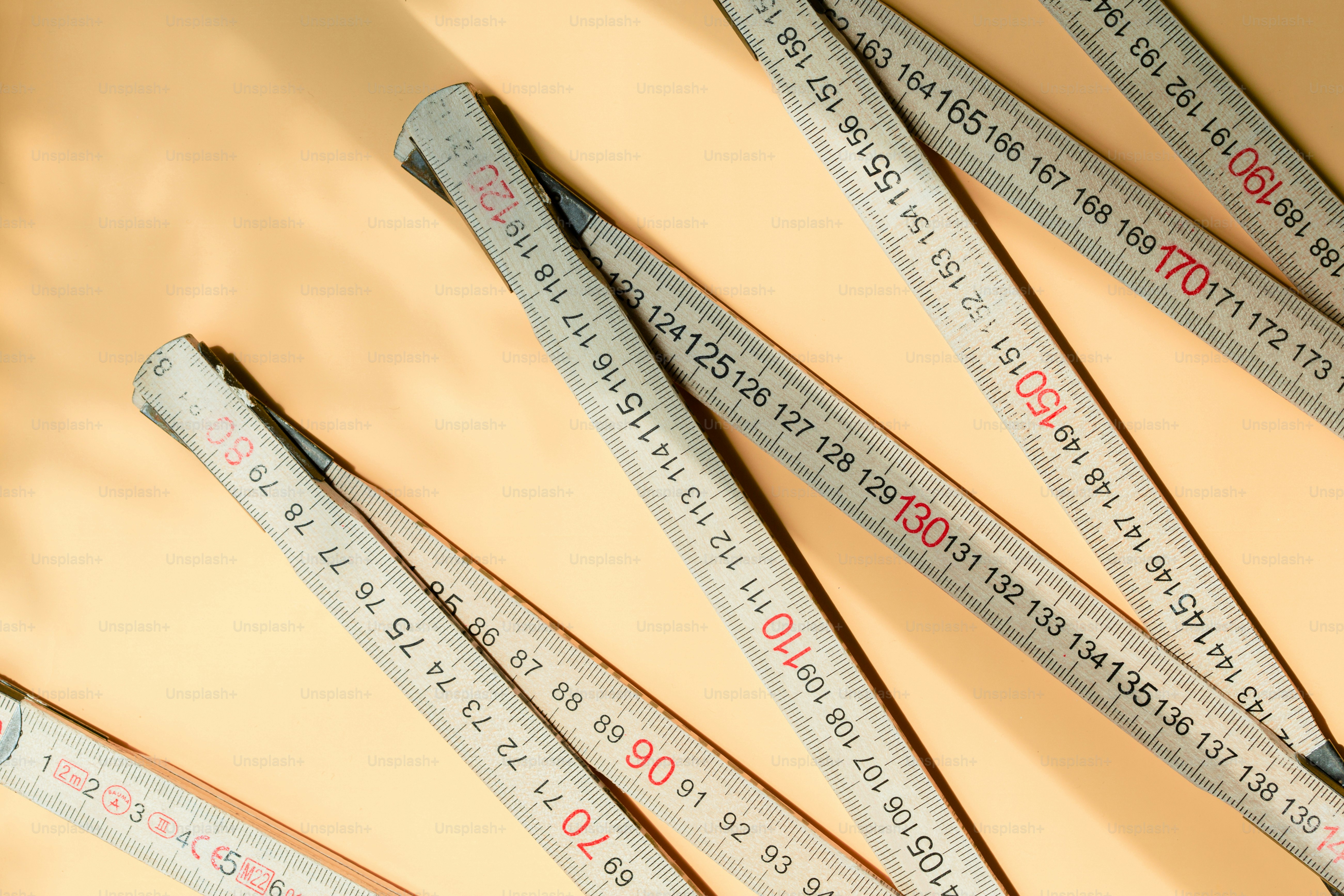 Folding ruler with centimeter markings on orange surface