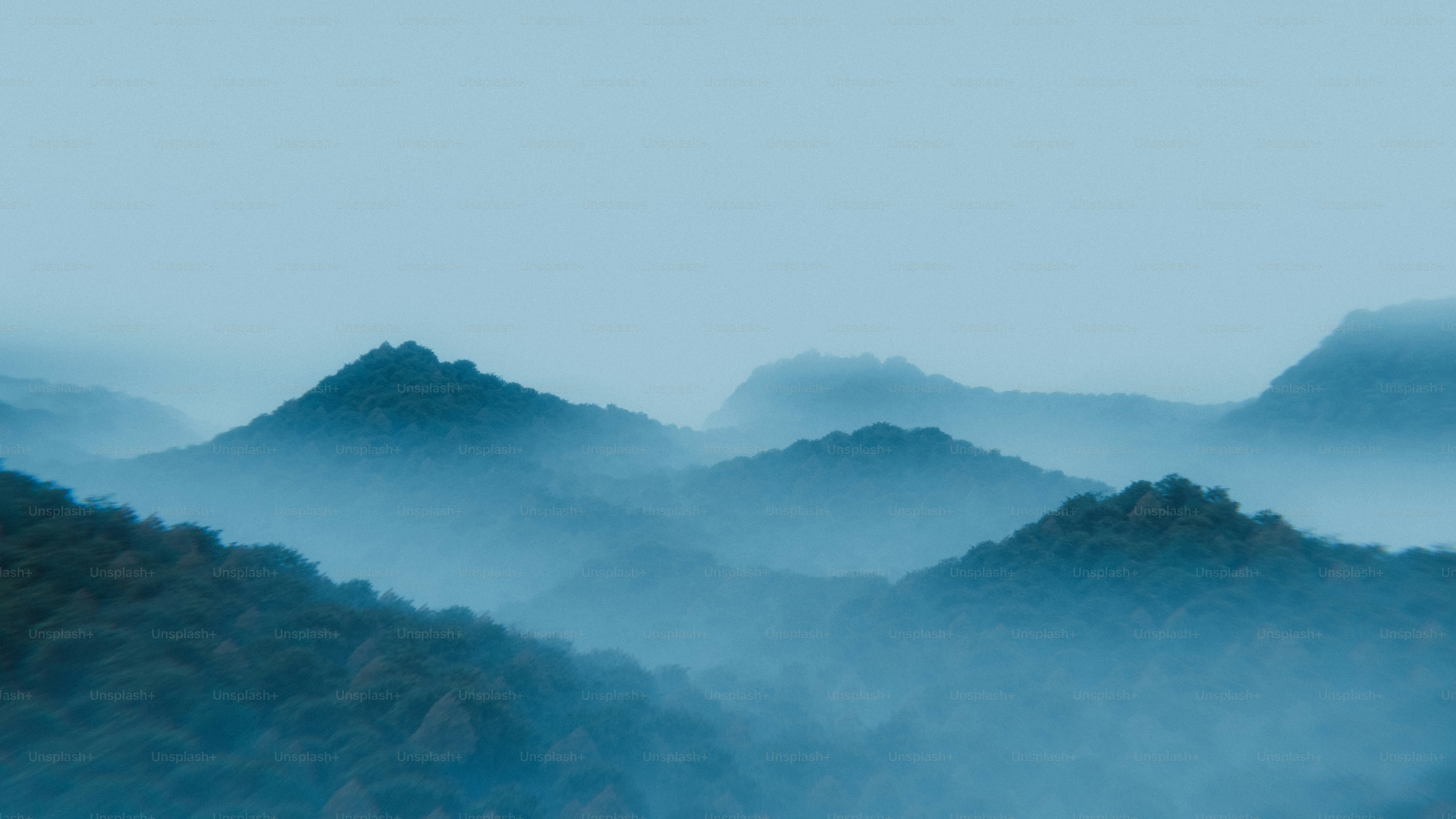 Layered mountains shrouded in blue mist