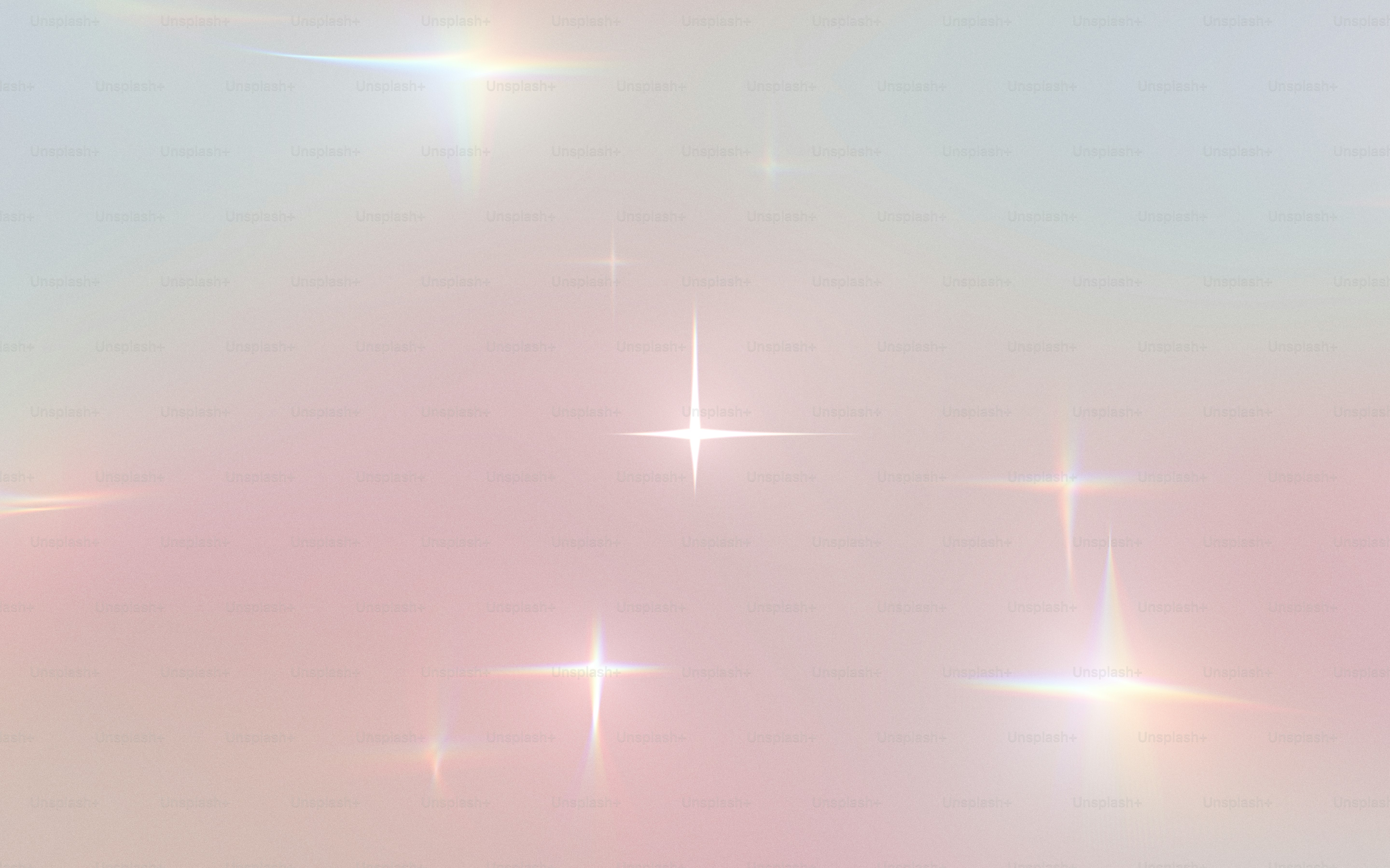 Soft pink and blue gradient background with bright sparkles