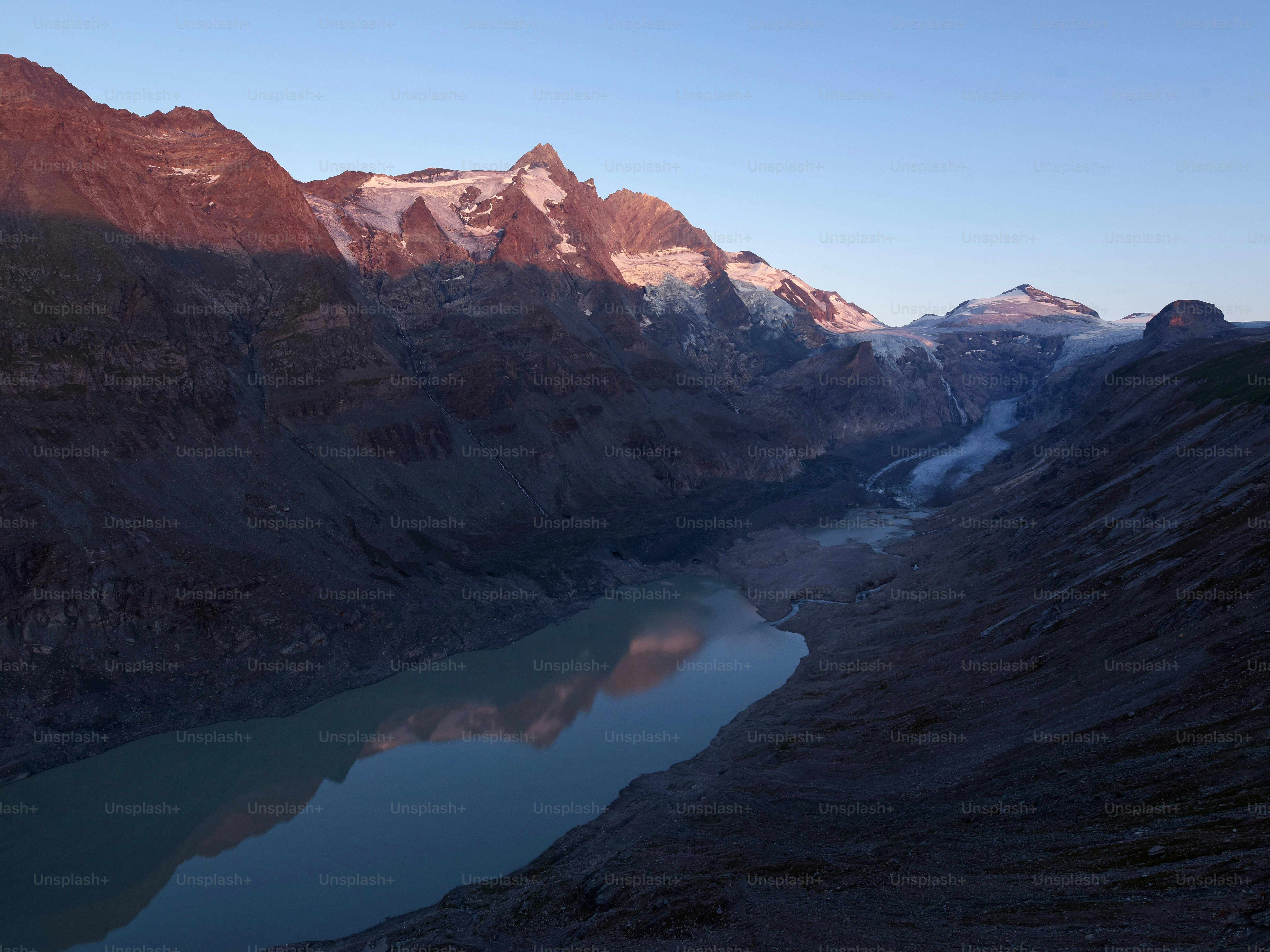 The Grossglockner mountain reflecting in the calm waters of the Sandersee lake