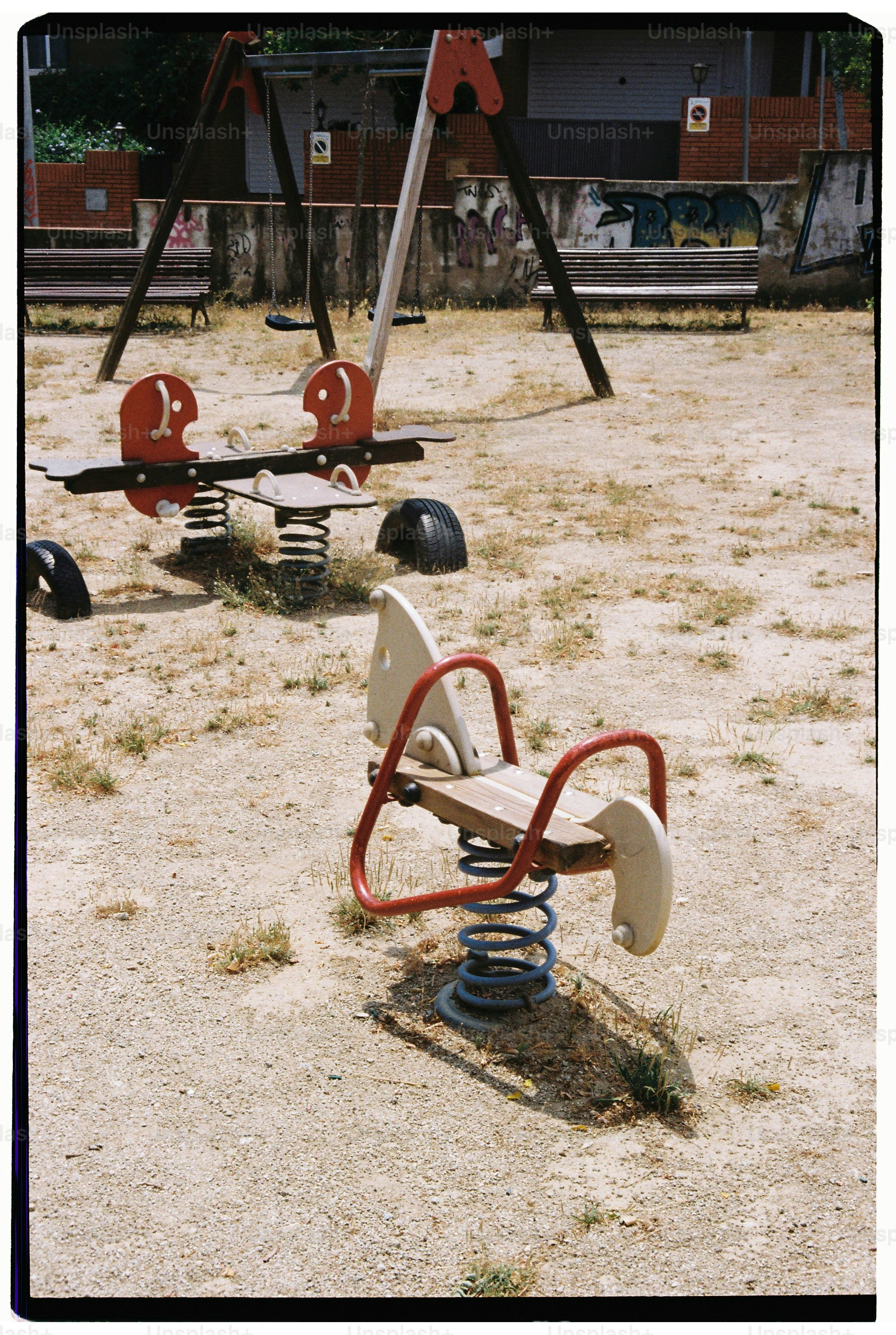 Empty playground with spring riders and swings