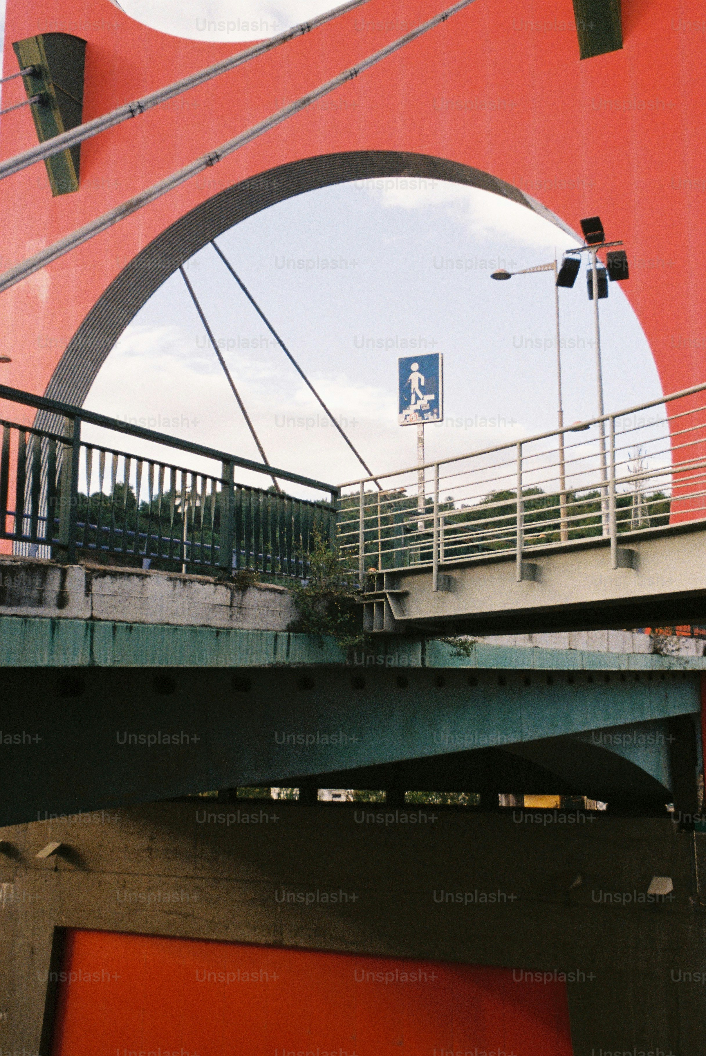 Red bridge arch spanning over two pedestrian walkways