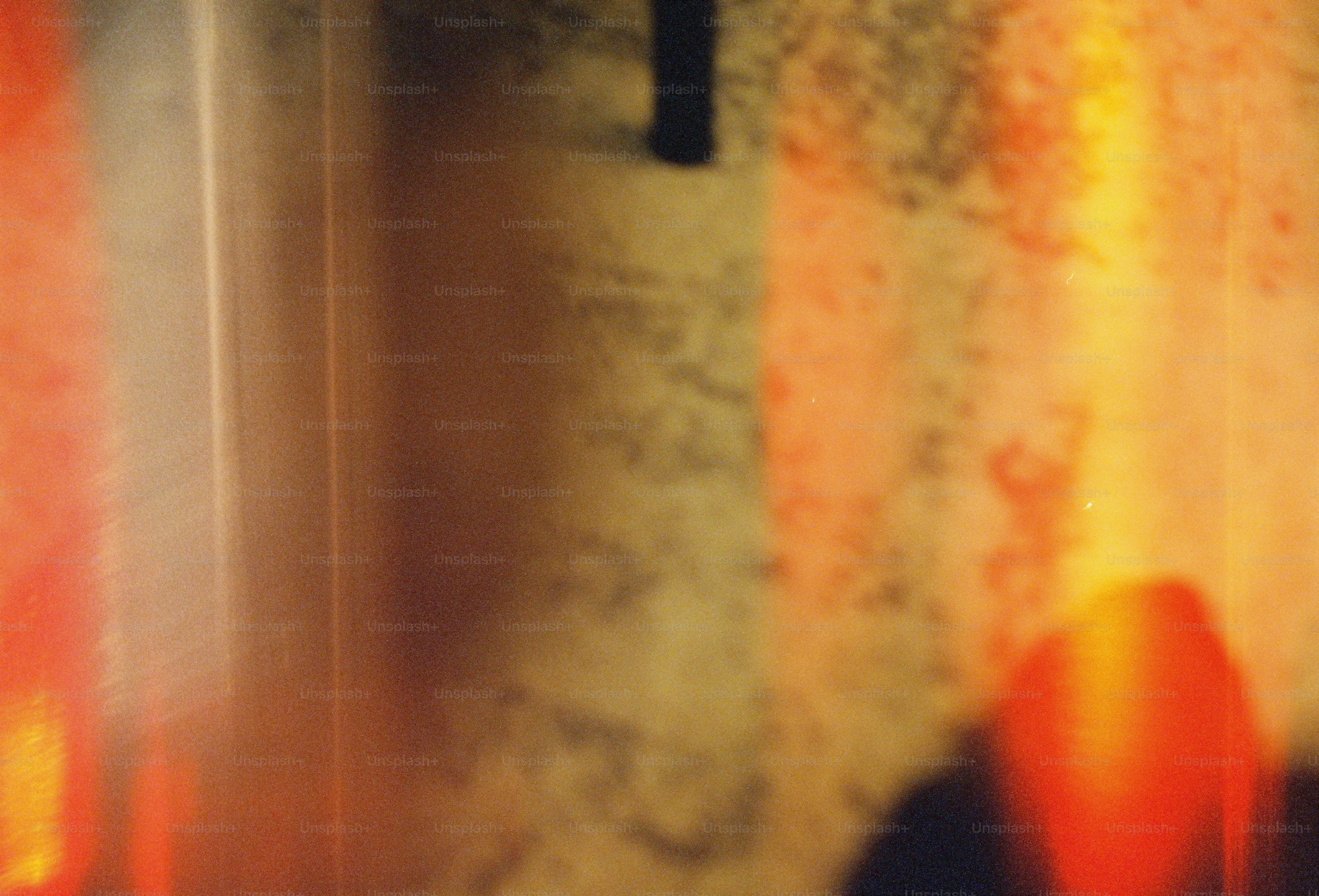 Warm orange and yellow light reflections on textured wall