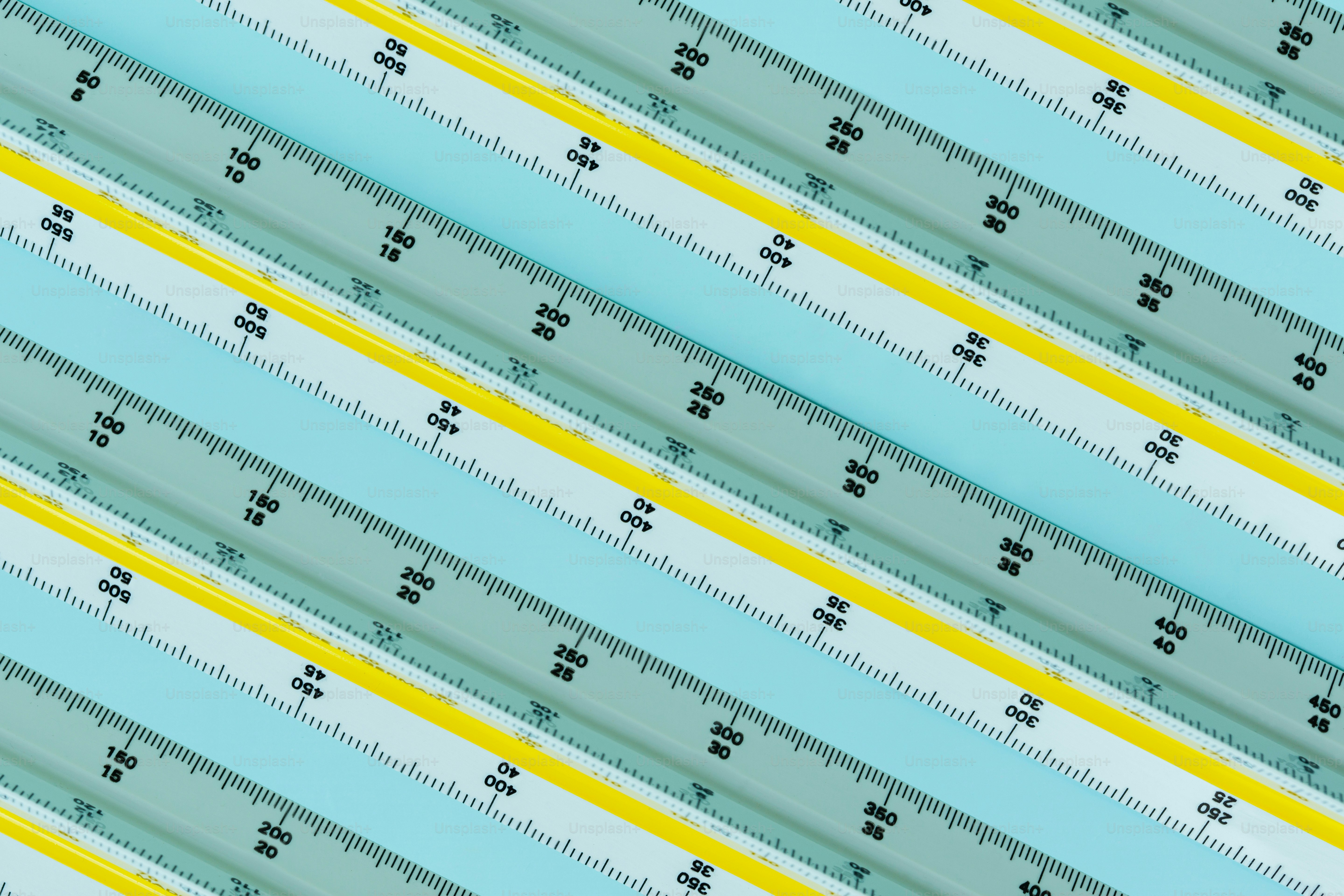 Parallel light blue and yellow triangular rulers with black measurement markings.