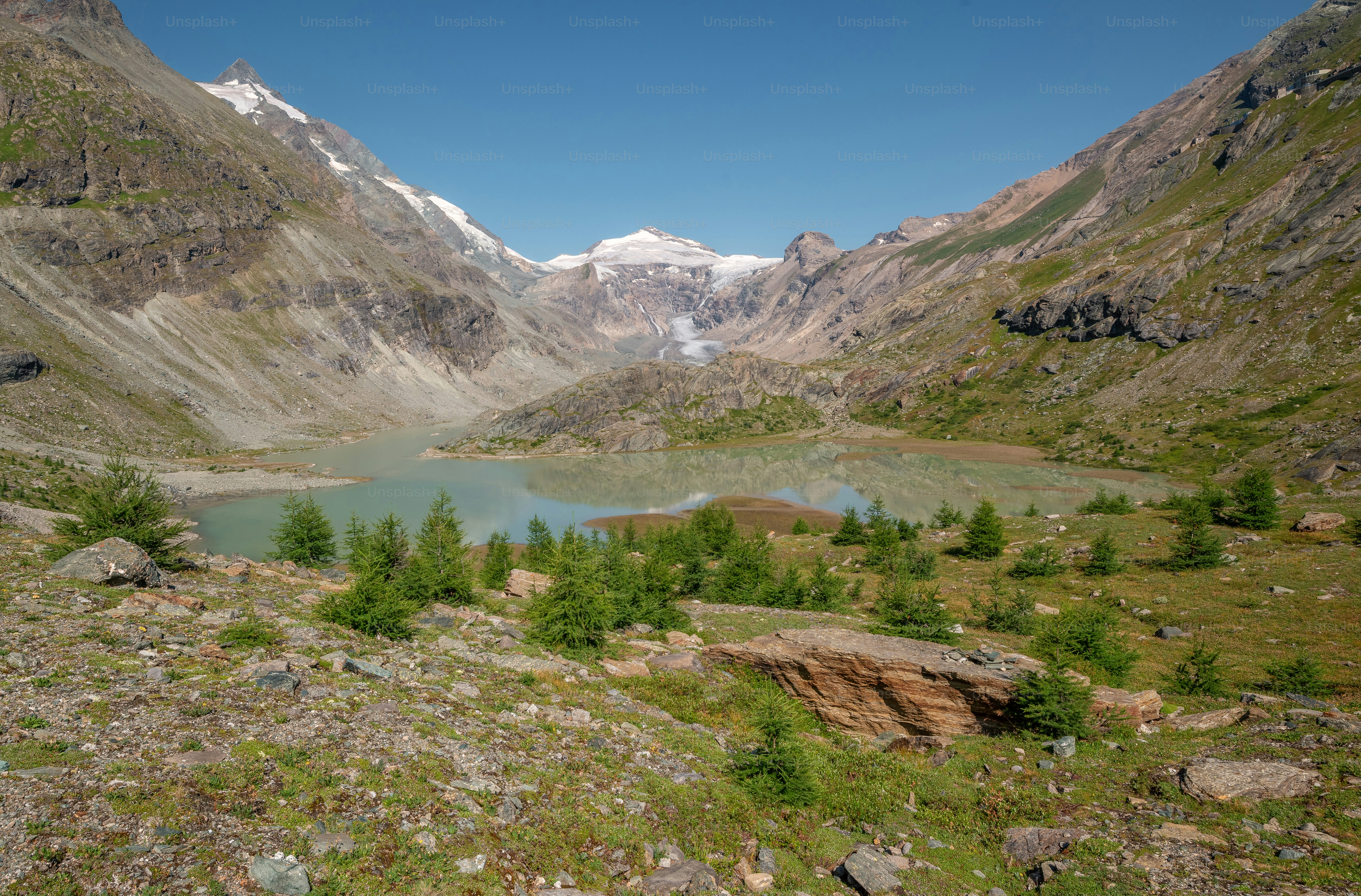 A glacial lake in the Hohe Tauern mountains of Austria under a clear sky