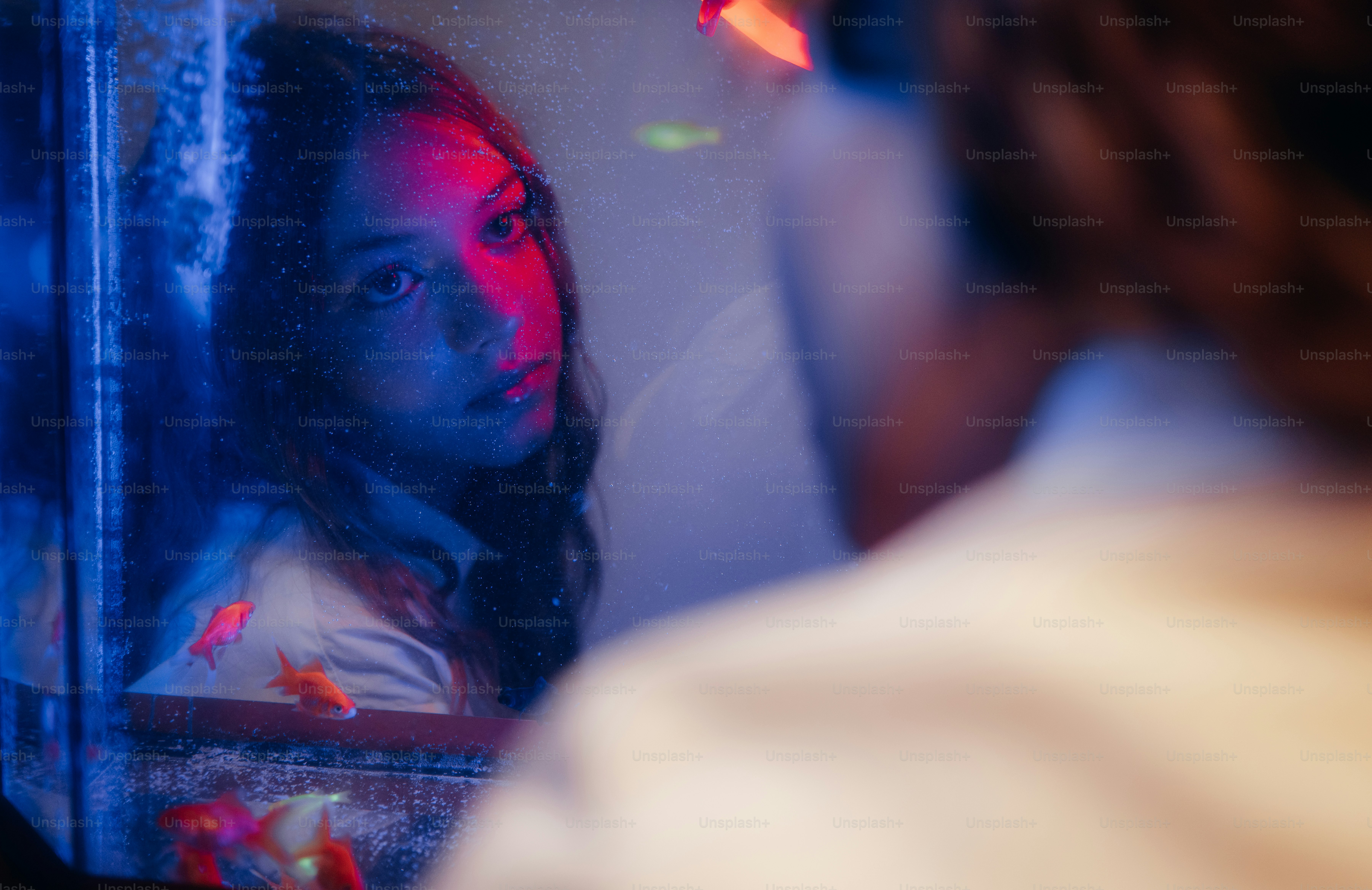 Woman's reflection in mirror with vibrant lighting