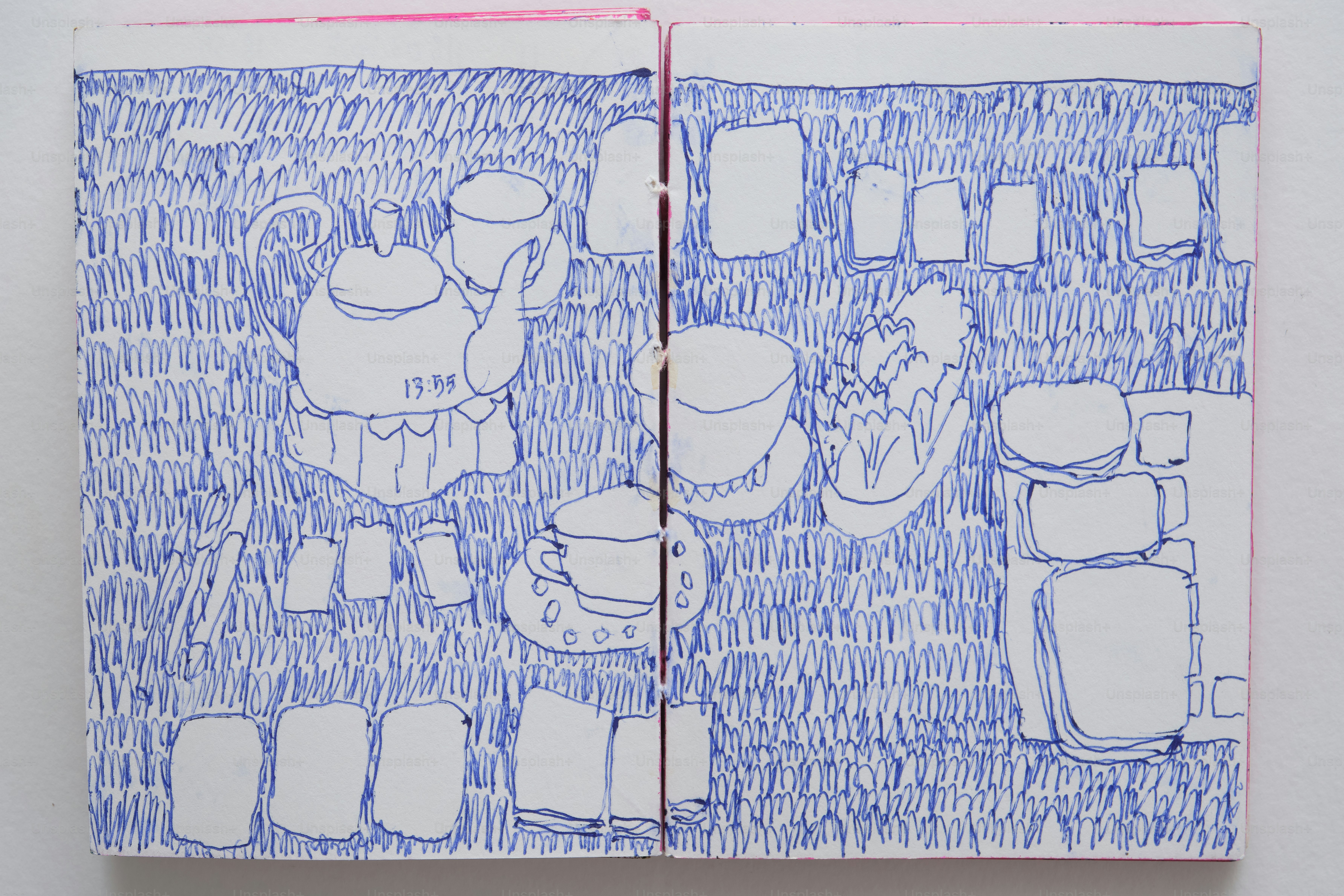 A blue ink drawing of a teapot and teacups on a grassy field