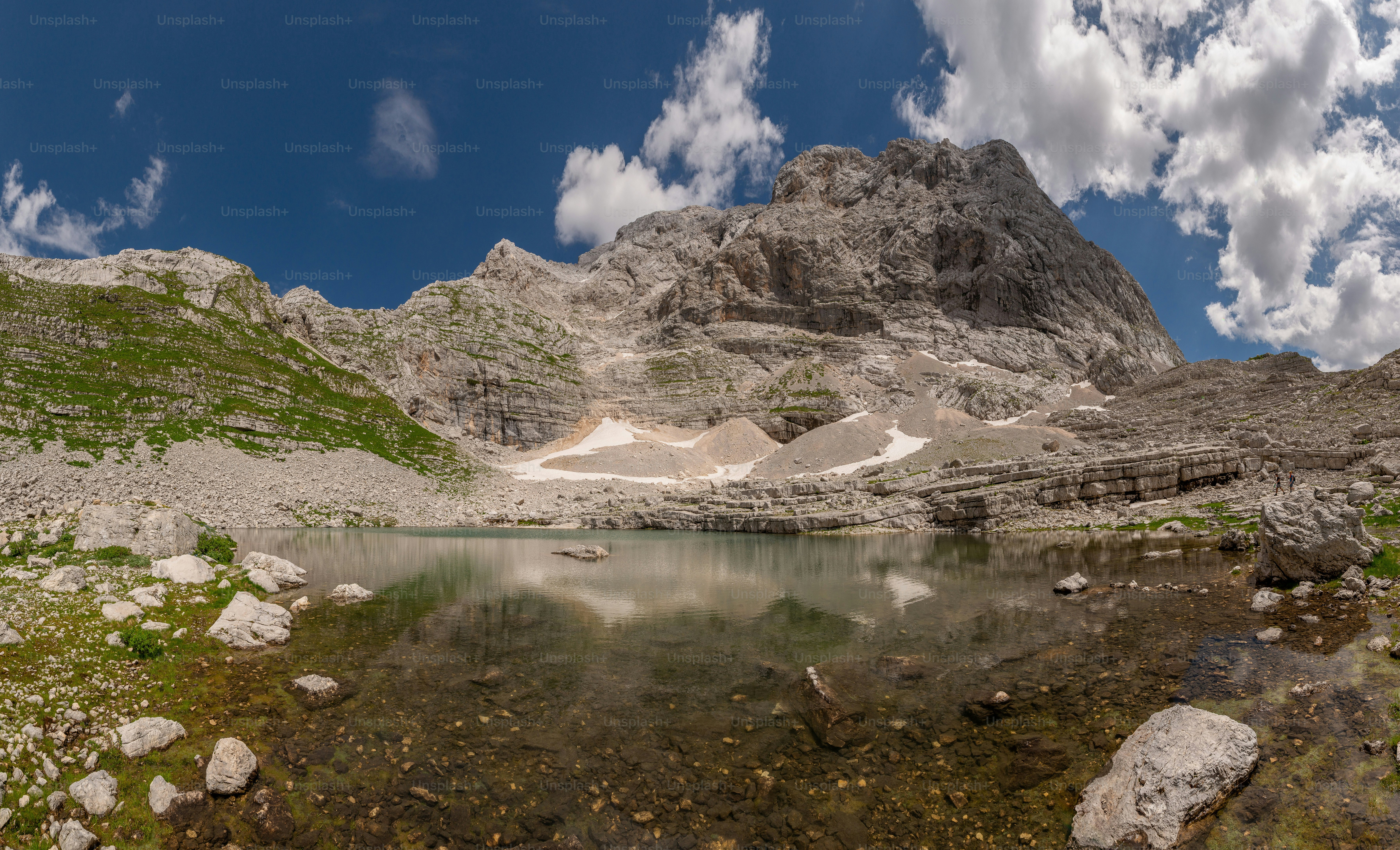 A glacial lake reflecting a rocky mountain peak in Triglav National Park, Slovenia