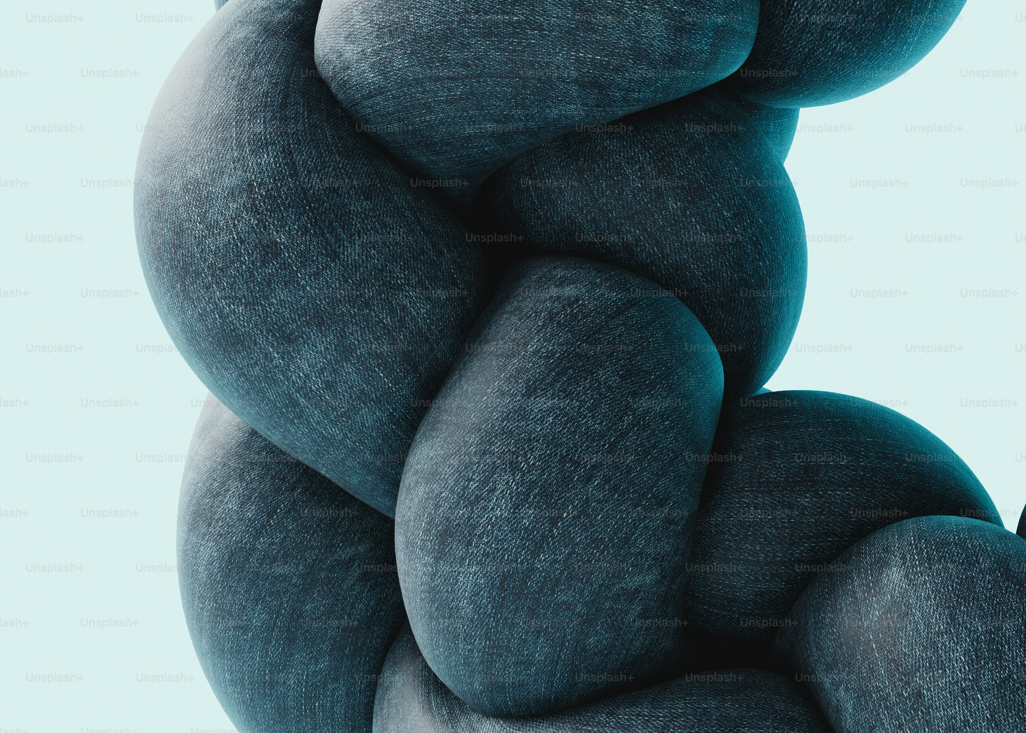 A braided structure made of dark blue denim fabric against a light background