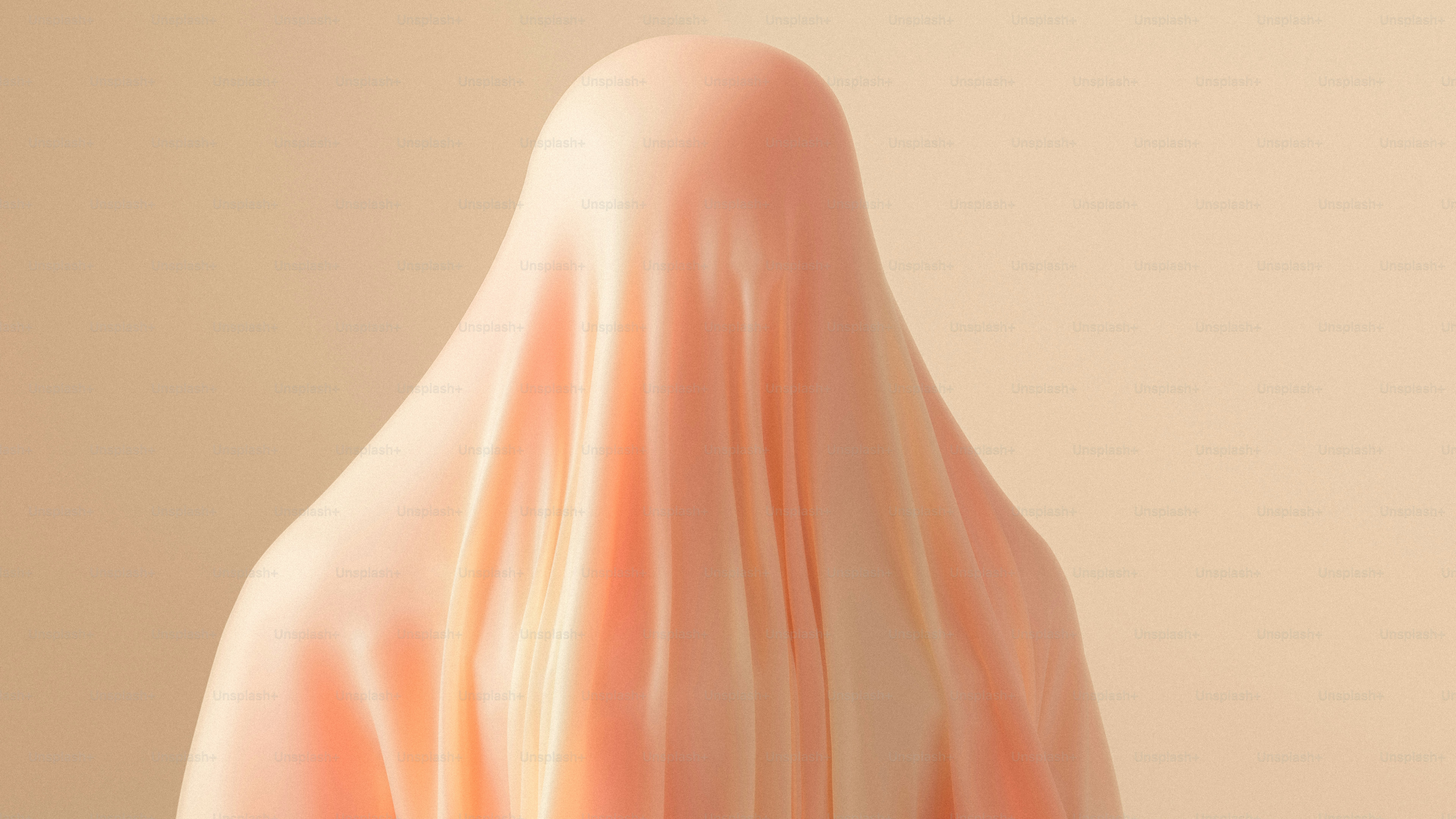 A person draped in a smooth peach-colored fabric against a matching background