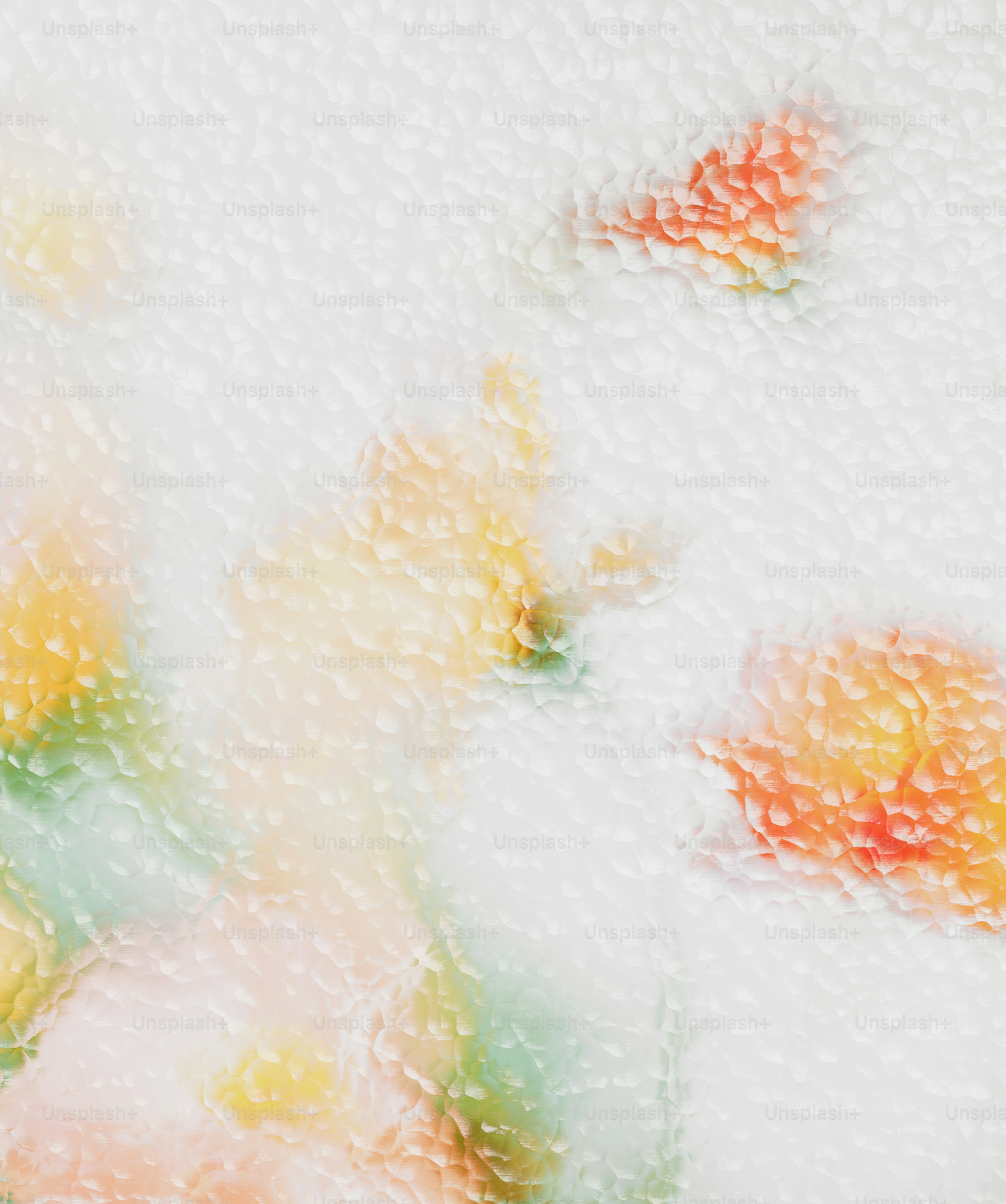 Blurred orange and yellow floral shapes behind a textured glass surface.