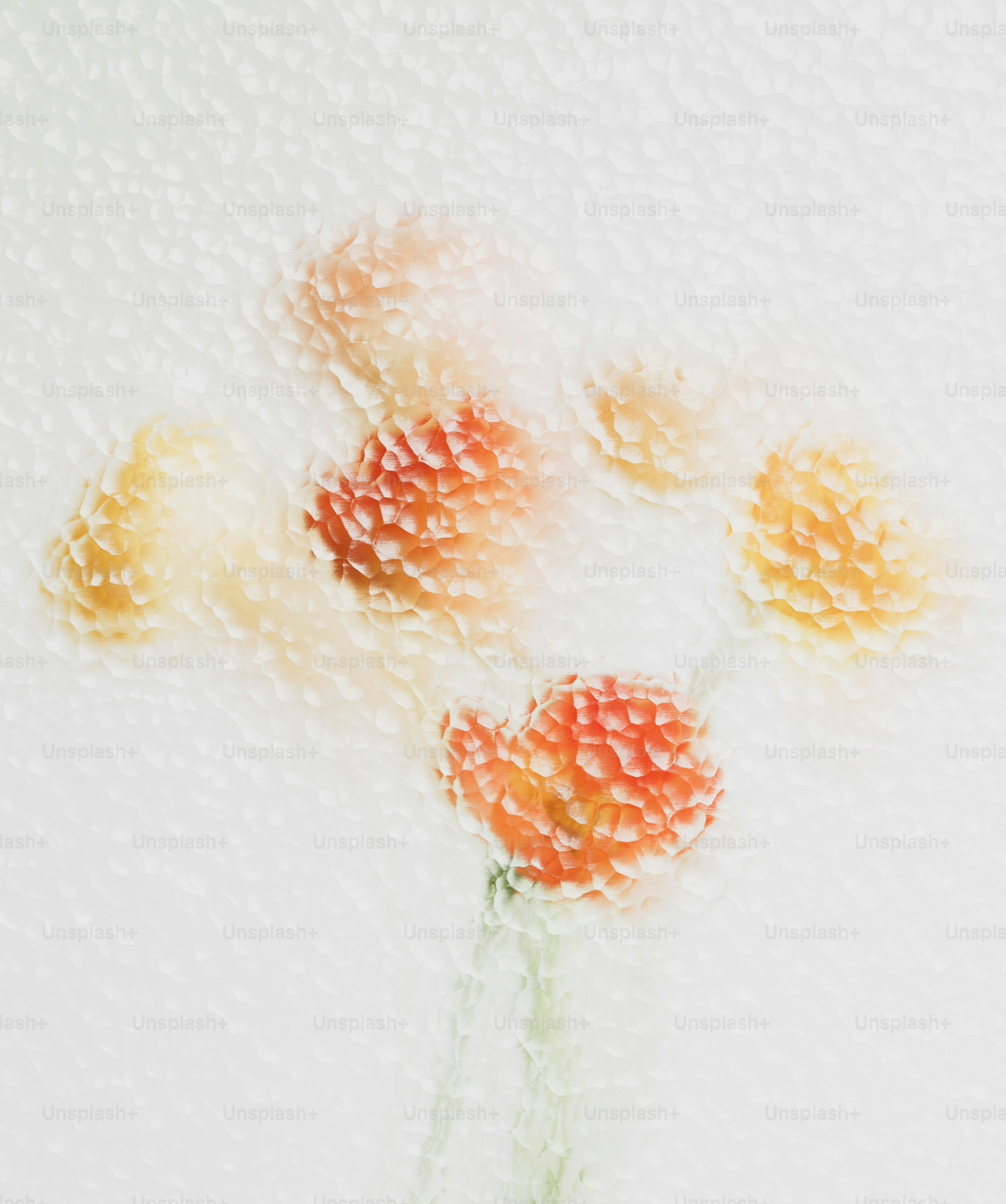 Orange and yellow flowers blurred behind a textured glass surface.