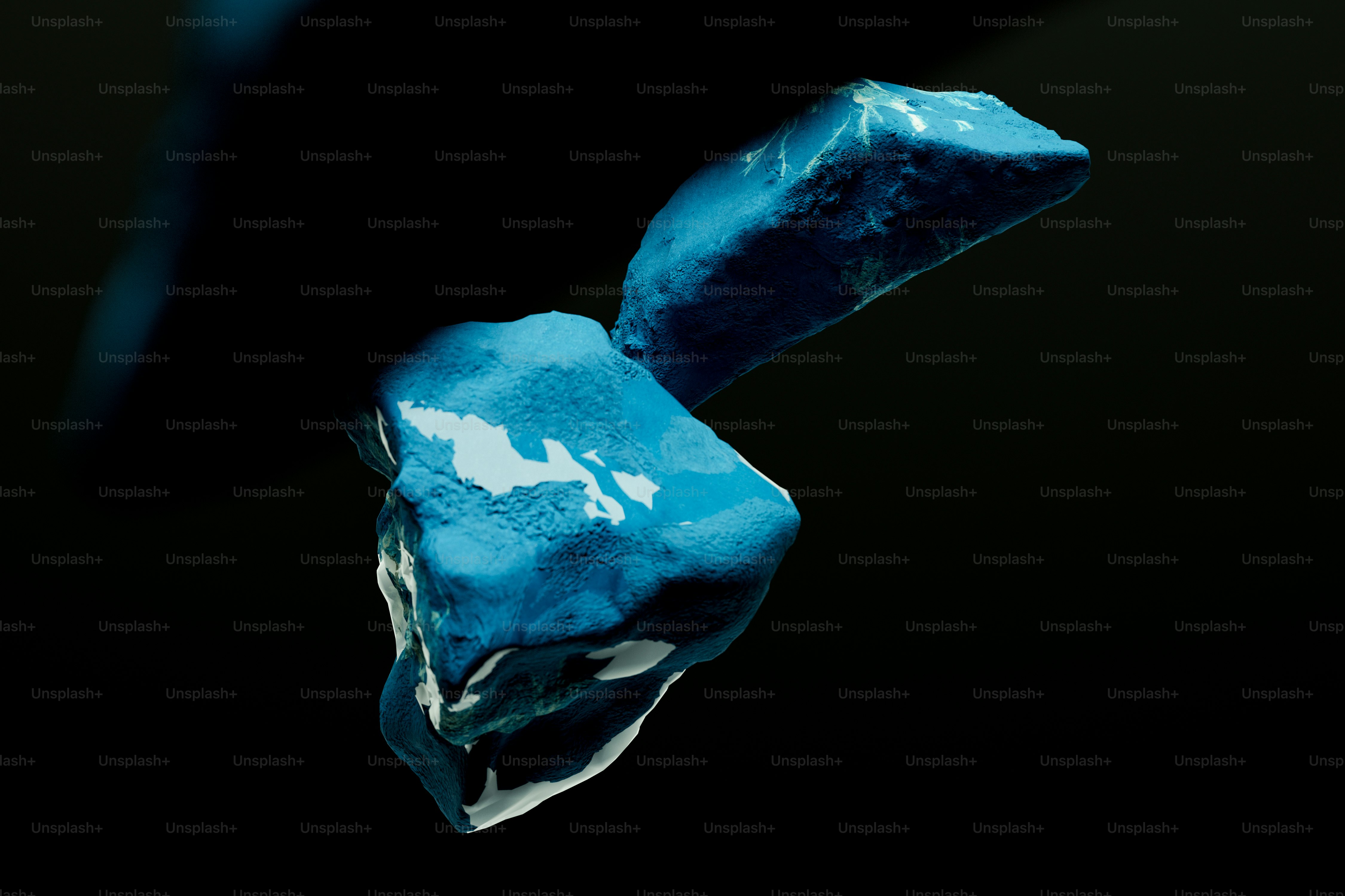 Two jagged blue rocks floating against a dark black background