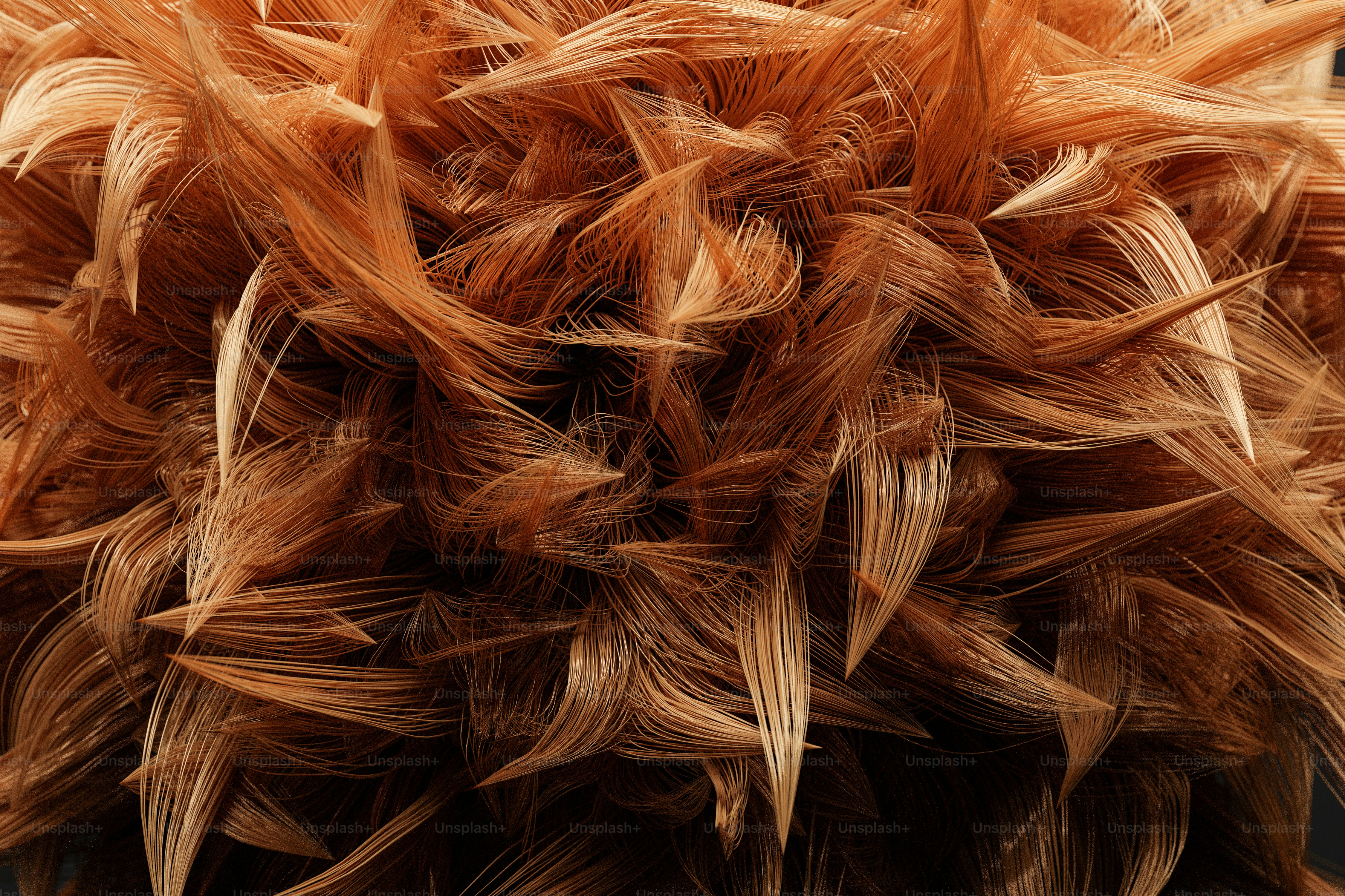 A dense cluster of fine, light brown synthetic hair strands