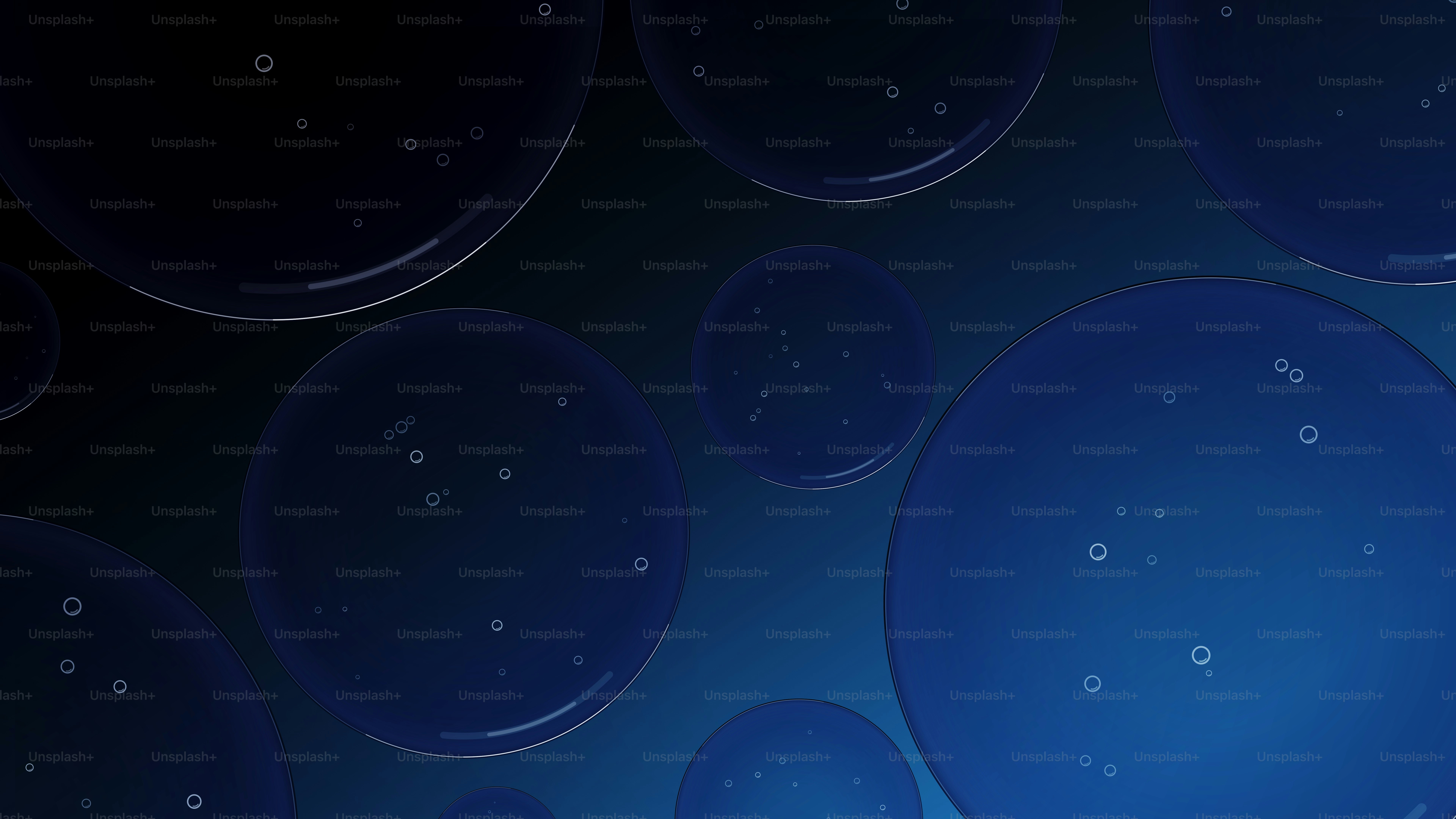 Translucent blue spheres with tiny bubbles floating against a dark gradient background.