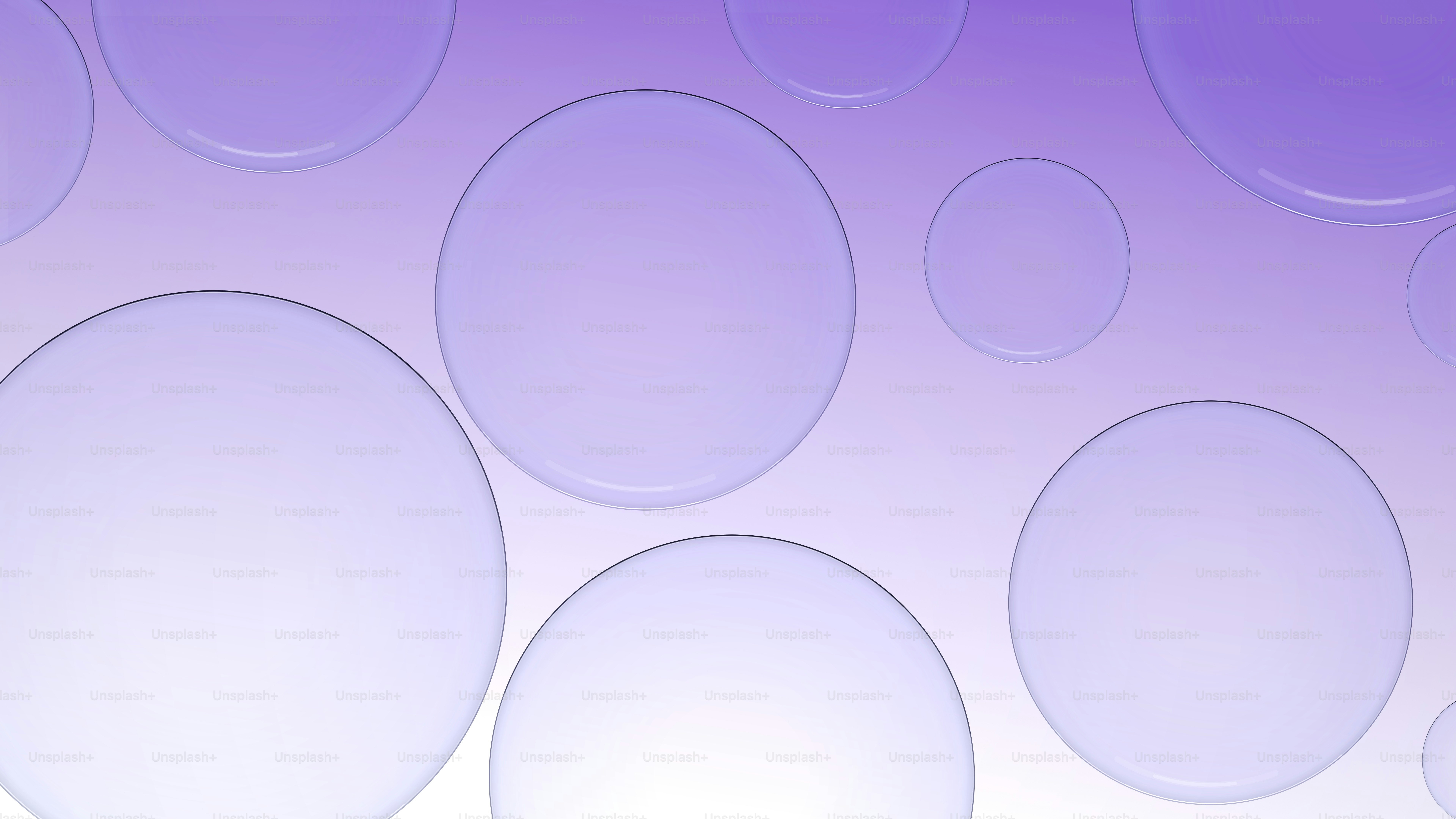 Transparent circular shapes floating against a soft purple gradient background.